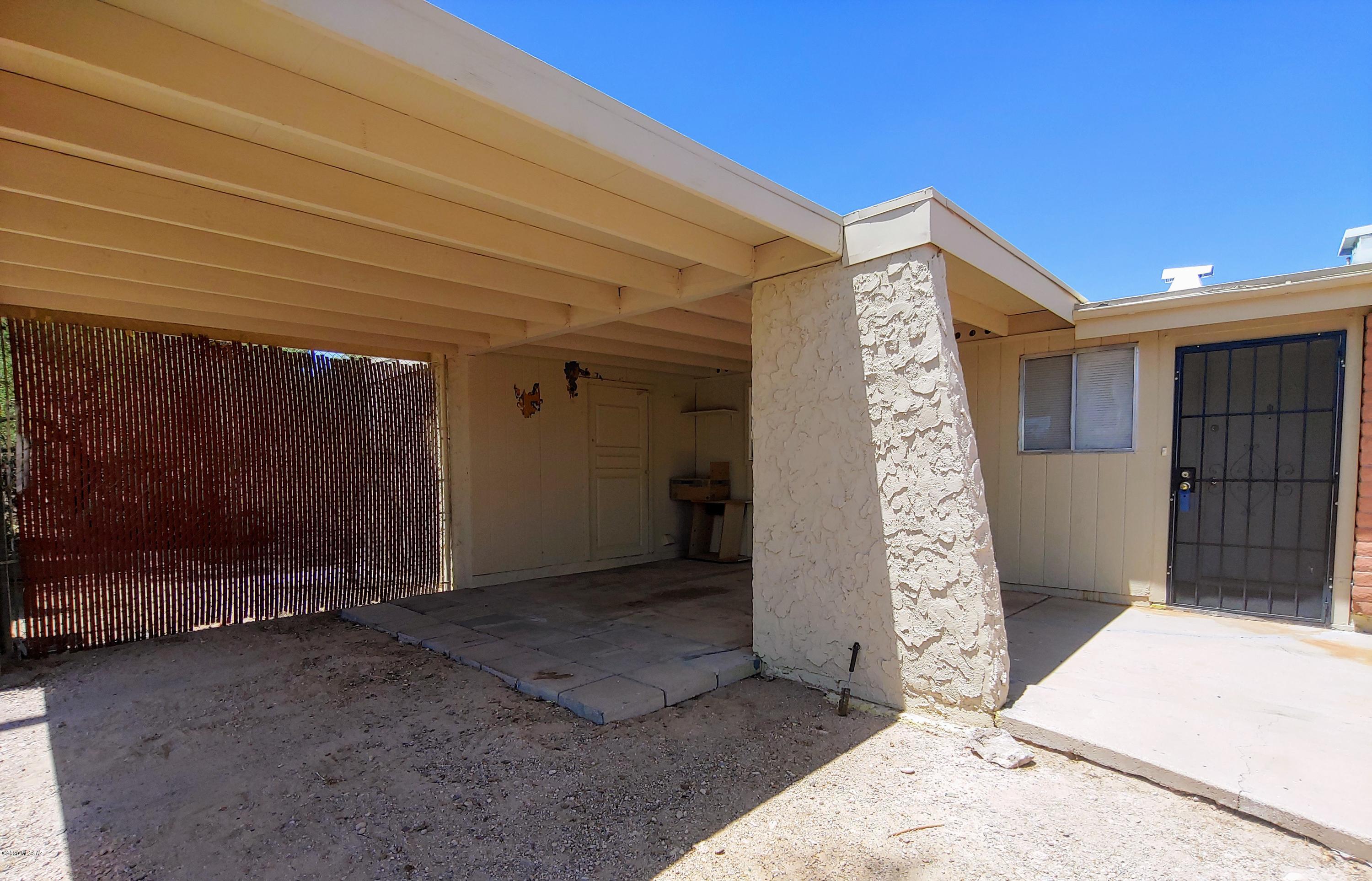 Southwest home 3bd/ 2 ba with bonus features including but not limited to, large yard with alley access, workshop, large family room, extended pantry closet, and laundry room off carport.