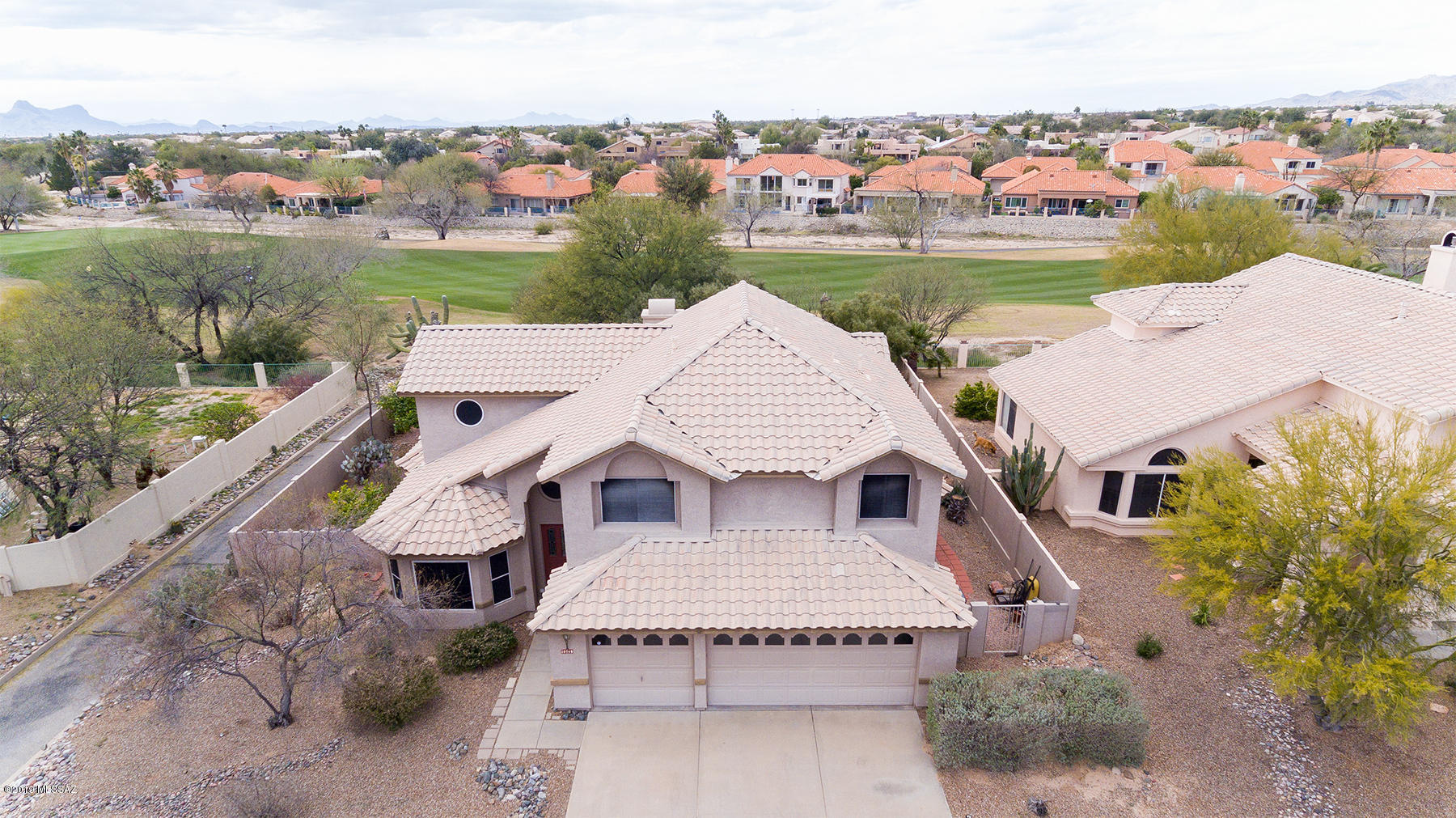 Oro Valley living at its BEST! 4 BR, plus bonus rm, 2.5 bath home situated on Popular Conquistador golf course w/a stunning view! Family rm w/fireplace, off kitchen, w/corian & breakfast nook make for spectacular entertaining! Your family will love the spa, view & outdoor living! Guests will enjoy the formal dining off spacious living rm & of course the incredible setting! Lg master suite, w/garden tub & double sinks also down stairs-as well as a powder room, laundry rm & 3 car garage for all your toys! Remarkable upstairs space too-featuring 3 Bedrooms (one with no closet) plus an awesome extra area perfect for play, study or your favorite hobby! You'll never want to leave home! Situated  on the 9th hole of golf course! Check out golf, tennis membership at the Oro Valley Community Center