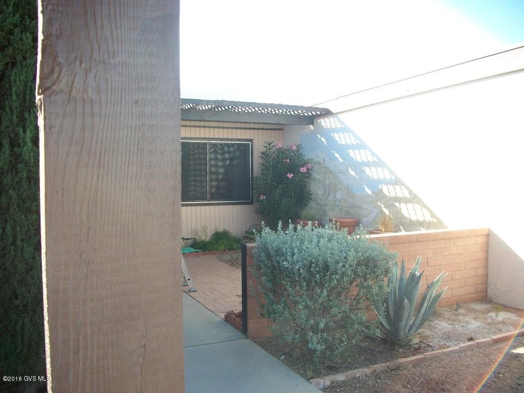 Has GVR. Enjoy mountain views form front Patio & lovely vibrant sun Rises. sunsets from rear patio, all tile except bedrooms. Extra storage off rear patio, . Room has a workshop. Close to a GVR Rec Center right in this development. Granite counters. Home is updated & ready to move in. Unfurnished. Home has AZ room with HVAC piped in. Roof recoat 2013. New HVAC 2014. New disposal.