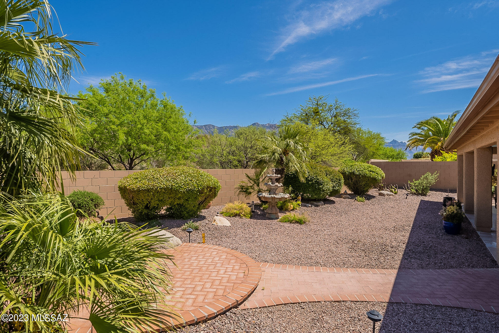 Sited on a large private lot with mountain & desert views, this popular Diego model features new ceramic tile & wood flooring. Updated kitchen boasts eng stone counters, soft close cabs w/pull outs, Blanco sink, 5 burner gas stove, huge SS refrigerator, solar tube & bay windows. Cozy family room with wood burning FP, plantation shutters, lovely built-in wall unit & track lighting. Custom designed wrought iron security doors on front door, master bedroom & family room doors. Primary bedroom has en-suite w/walk-in tub/shower, double vanity & 2 closets. Large laundry room w/new Maytag washer & dryer, lots of cabs & counter space + laundry tub. Epoxy coated ext garage w/tankless water heater, 10 storage cabs, instant hot water. Lovely landscaping w/raised brick patio in back yard.