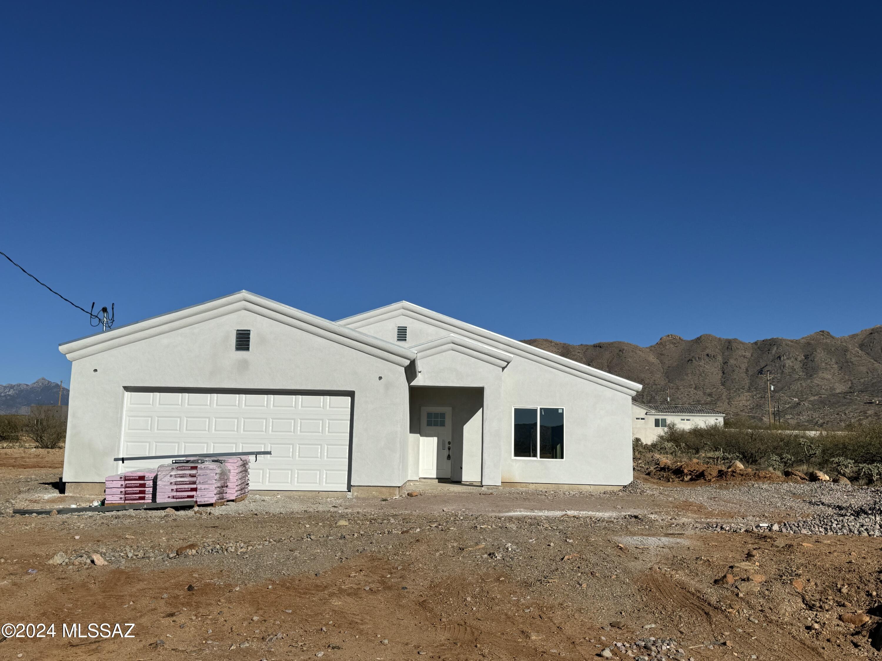 Brand new build in  Rio Rico on .66 acres should be finished by February 2024! Upgraded oversized beautiful tile Grey and White throughout the entire home. Open Floorplan with spacious Living room overlooking private culdesac in front and kitchen and dining area in back. Kitchen offers Island, upgraded stainless steel appliances with Refrigerator, dishwasher,electric cooktop  stove and microwave. Dual Paned Windows. Slider doors in back lead to covered patio. 3 bedrooms and 2 bathrooms! 2 car garage. Home comes with 2 years builder warranty! 1485 SQ FEET!