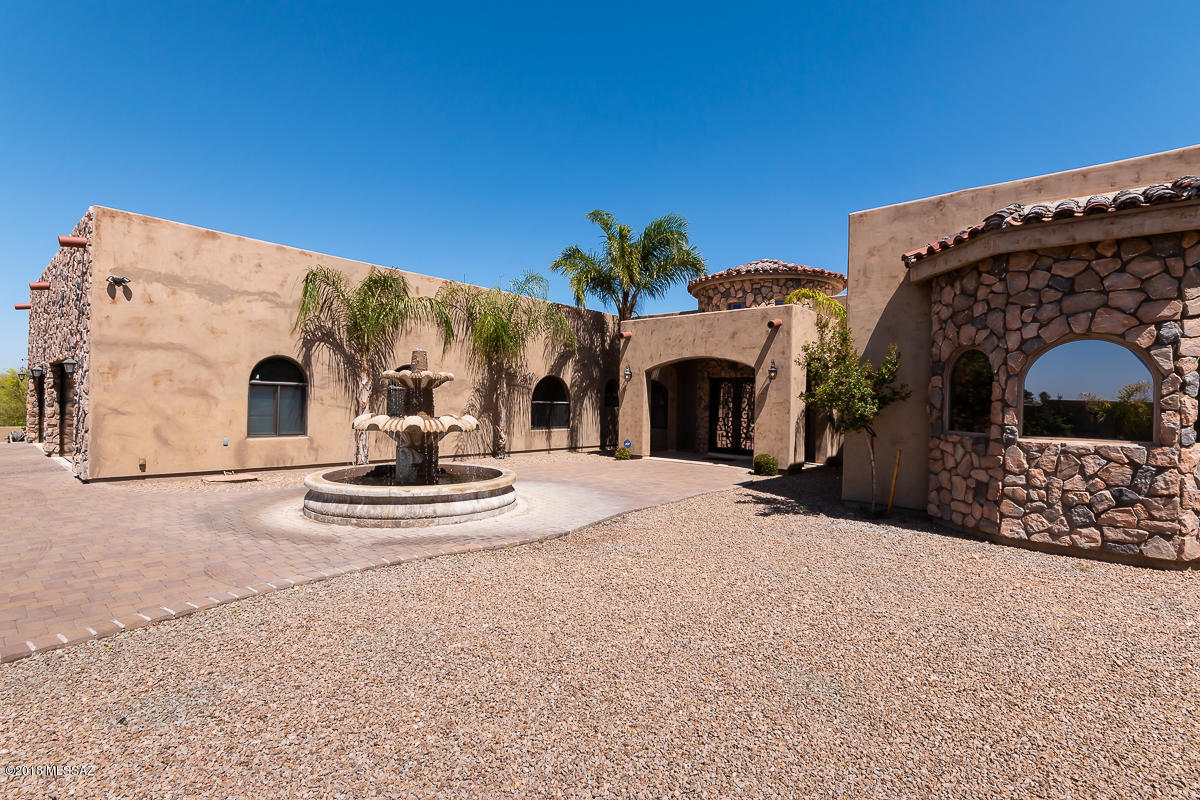 HUGE Price reduction! Motivated Seller.Wow! Check out this exquisite custom Mediterranean home located in excellent location with all the necessary shopping conveniences nearby. Lots of warm touches including colored non-painted smooth stucco, custom rock work in all the right places, and custom coved burnt brick ceilings. Bright and spacious split-bedroom floor-plan with separate great room and living room. You're going to love the natural tumbled stone floors and 12-foot ceilings throughout the home. Your family/guests will enjoy the privacy of their own bathroom and walk-in closet in every bedroom. Well thought-out kitchen, with beautiful cabinetry, granite counter-tops, high end appliances, convenient office space, and walk-in pantry. True entertainers delight with custom pool/spa w/ slide and waterfall features. Enjoy it!
