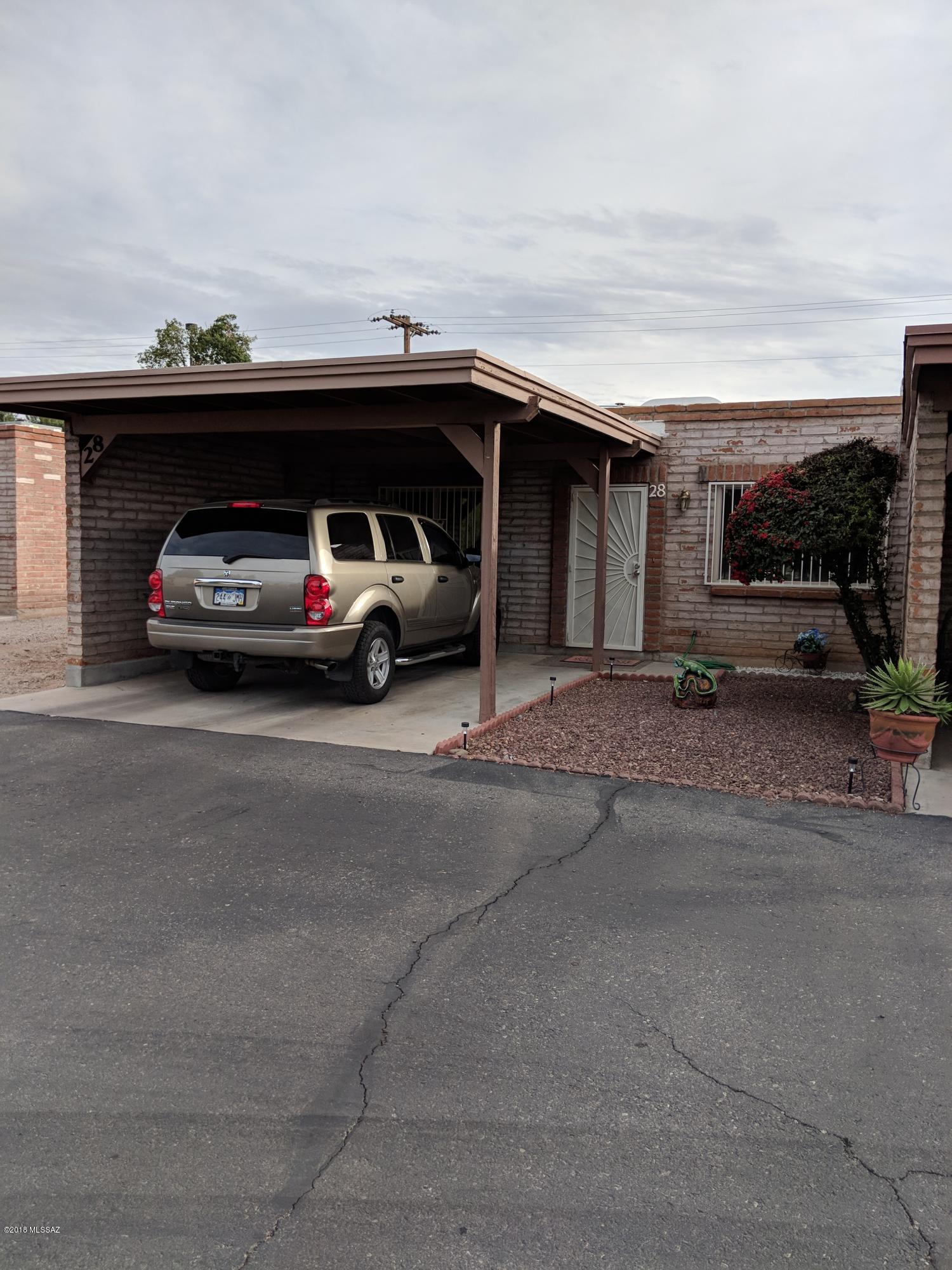 A winter visitors delight! Cozy and secure, this remodeled townhouse shows pride of ownership! Close to shopping, bus lines, medical services and restaurants. Features include covered patio, tuff shed, custom wrought iron window and door coverings, newer kitchen cabinets & kitchen appliances, A/C, dual-pane windows, ceiling fans and floor coverings. Washer/Dryer convey in ''AS-IS'' condition.