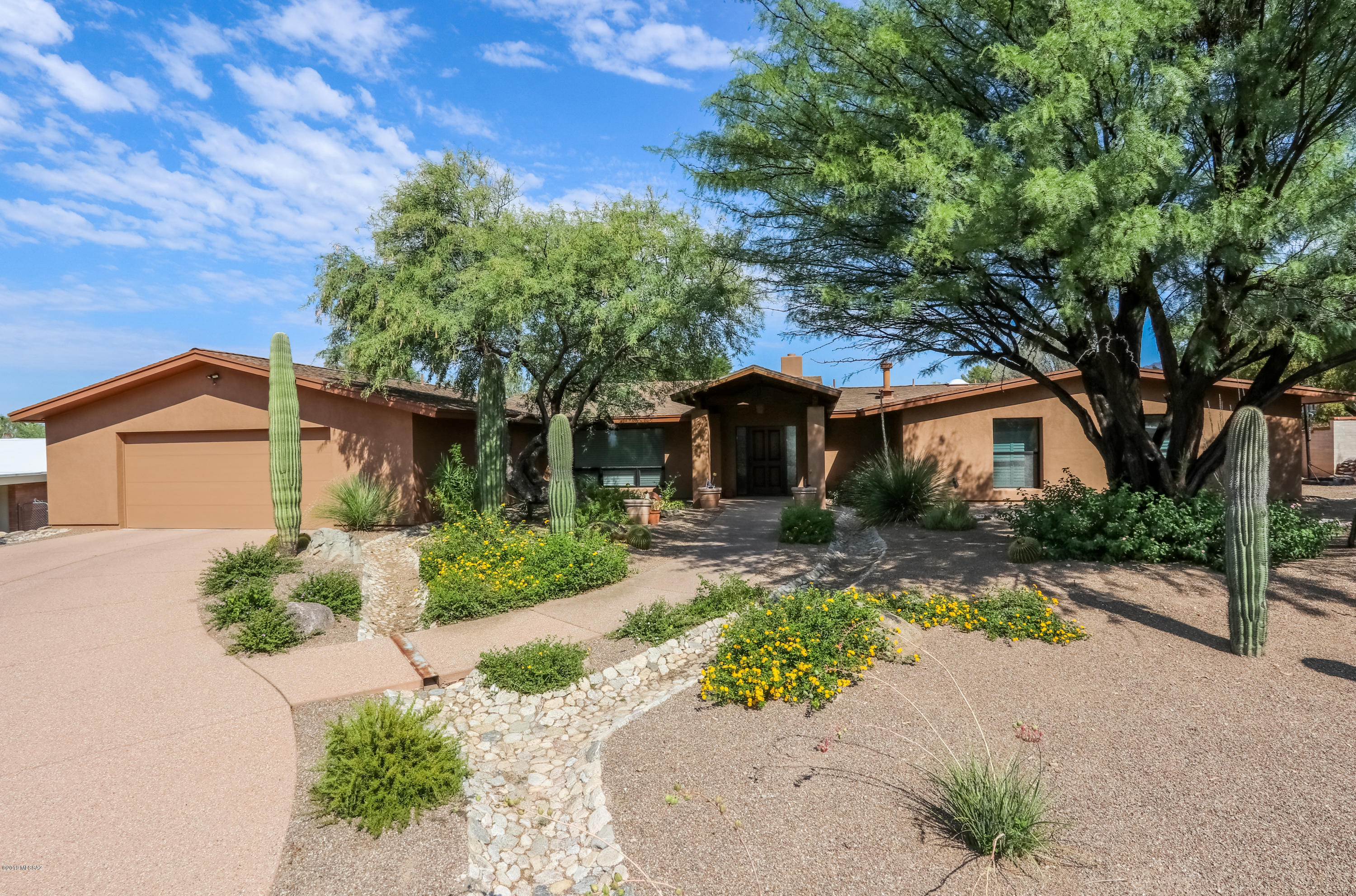 Don't miss this beautiful 4 bedroom/2.5 bath updated home in desirable Sabino Vista, located on a cul-de-sac. Chef delight gourmet kitchen with large island, granite countertops, cherry cabinets, soft close drawers, thermadore appliances and lots of storage. Eat at the bar that overlooks oversized family room with stone fireplace. Lots of recessed lighting, bright and open floor plan. Master suite with large en suite, large walk-in shower, soaking tub, dual sinks and walk in custom closet. Designer touches throughout the home. Entertainers backyard with wrap around covered patio, pebble tec pool with built-in lagoon and flagstone deck. Mature landscaping with mountain views. This home has it all and is move in ready. It won't last long!