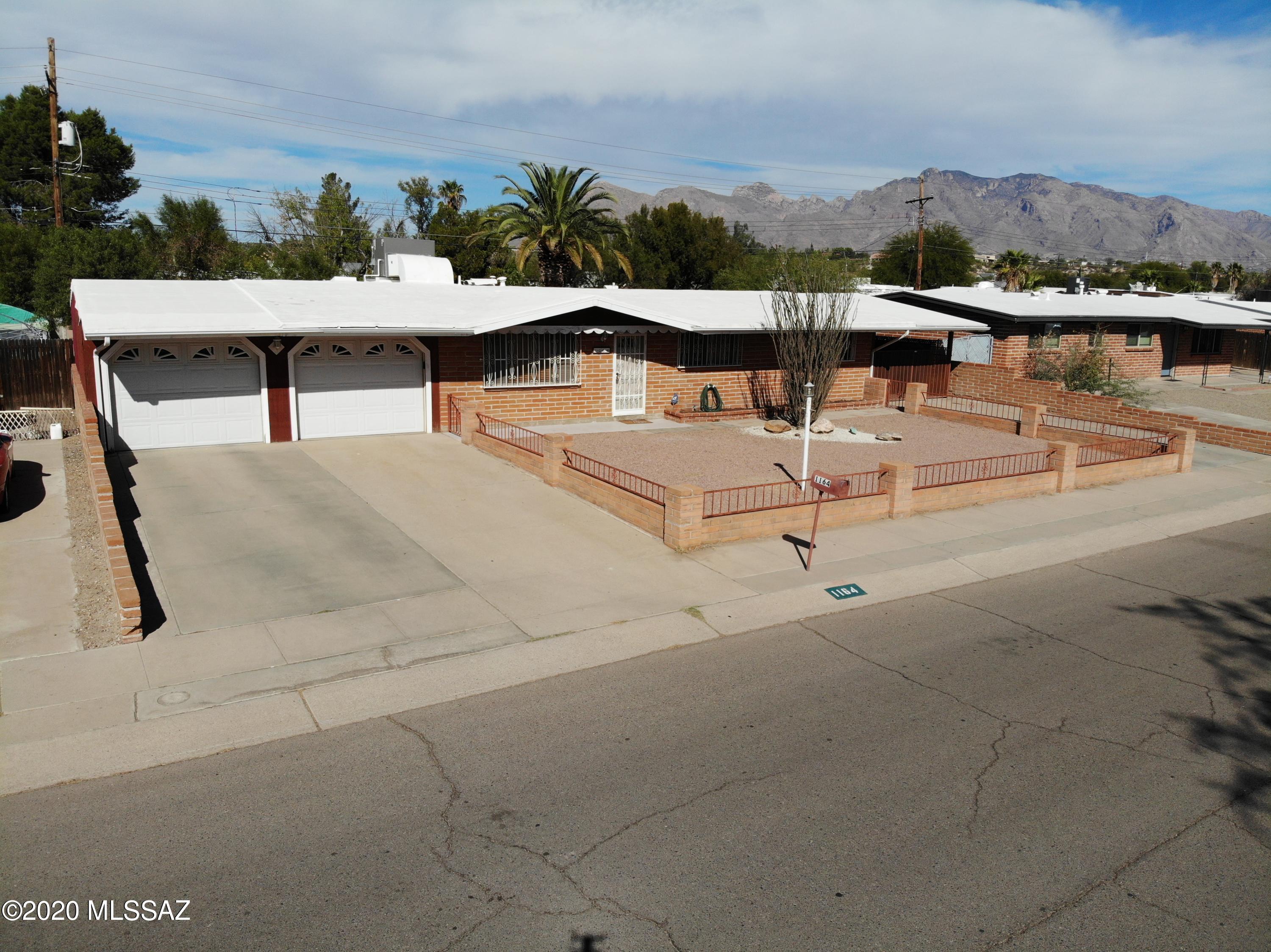 Amazing family home in a desirable neighborhood. Large living room, beautifully redone kitchen, huge added on Arizona room. No HOA and paved parking in front for at least 3 vehicles and a 2 car garage. Enjoy a large backyard with covered porch, shed, as well as secured/covered parking for 2+ cars or recreational vehicles along the east side. Appliances are negotiable, seller has newer washer/dryer and refrigerator. Brand new A/C. 

Fantastic location just off River Rd and not far from shopping centers and amenities. Very short walking distance to the Rillito River Loop/Path and the Children's Memorial Park.
