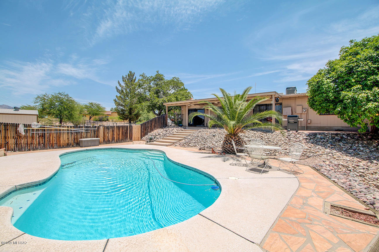 Lovingly cared for and full of charm! This fabulous  home is waiting for you on a private 1.29 acre lot located in highly desired Casas Adobes! Offering 3 bedrooms, 2 bathrooms plus a den/office, there is space for everyone! Relax under your huge covered back patio while you take in the mountain views. Cool off during those hot summer days in the beautiful backyard pool. The tastefully updated kitchen won't disappoint, boasting stainless steel appliances and a range with double ovens! There is plenty of room to entertain in the large dining area or gather by the fireplace in the spacious family room. Don't forget to bring your toys! This home has more than enough space for your RV, boats and horses! Located within minutes of shopping, dining, and hospitals this home is truly a rare find!