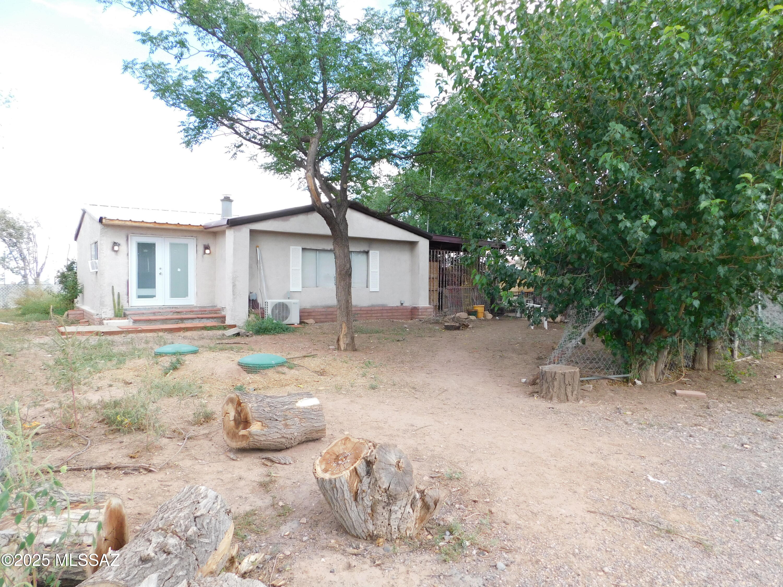 Enchanting Hobby Farm Retreat with EXPANSIVE 3 BR/2 BA Main House -Private well AND City water* oversized garage/workshop + additional building for guests or hobbies or residential business - Modern Upgrades & Endless Possibilities! Discover your slice of paradise with this beautiful Property! 2023-2025 RENOVATIONS INCLUDE: New septic system (10/2022), private well has new electrical, expansive window and door replacements, and a stunning new back deck perfect for family BBQs or al fresco dining under the stars. Versatile Outbuildings: A spacious workshop with a solid foundation and ample outlets. Another large building (needs some TLC) perfect for guest home or residential business. Many gardens and chicken coops. THIS HAS MANY SITE BUILT ADDITIONS, BUT IS A 1971 MANUFACTURED HOME. HIGHLIGHTS:

PRIVATE WELL and city water
New Septic 2022
New Electrical Main Box in Master Bedroom
New Electrical for Private Well
New Appliances
New Bathroom vanities in both Bathrooms
New Cabinets in Kitchen
Upgraded ceramic tile in the Arizona Room
New Mini Split installed in Family Room
Working & incredible antique wood-burning cooking stove
Stalls with tackroom/barn space
Over 40 fruit trees/bushes, including Asian Pear, Fig, blackberry bush
Garden areas & chicken coop
New Deck off the home
2-4 car garage/workshop
Additional building can be a guest house, a residential business, or office
Very short walking distance to the award-winning McNeal Elementary
The main house has incredible and expansive floor plan
The Master Suite has a private door to the deck
New dual-pane windows and doors

Welcome Home!!