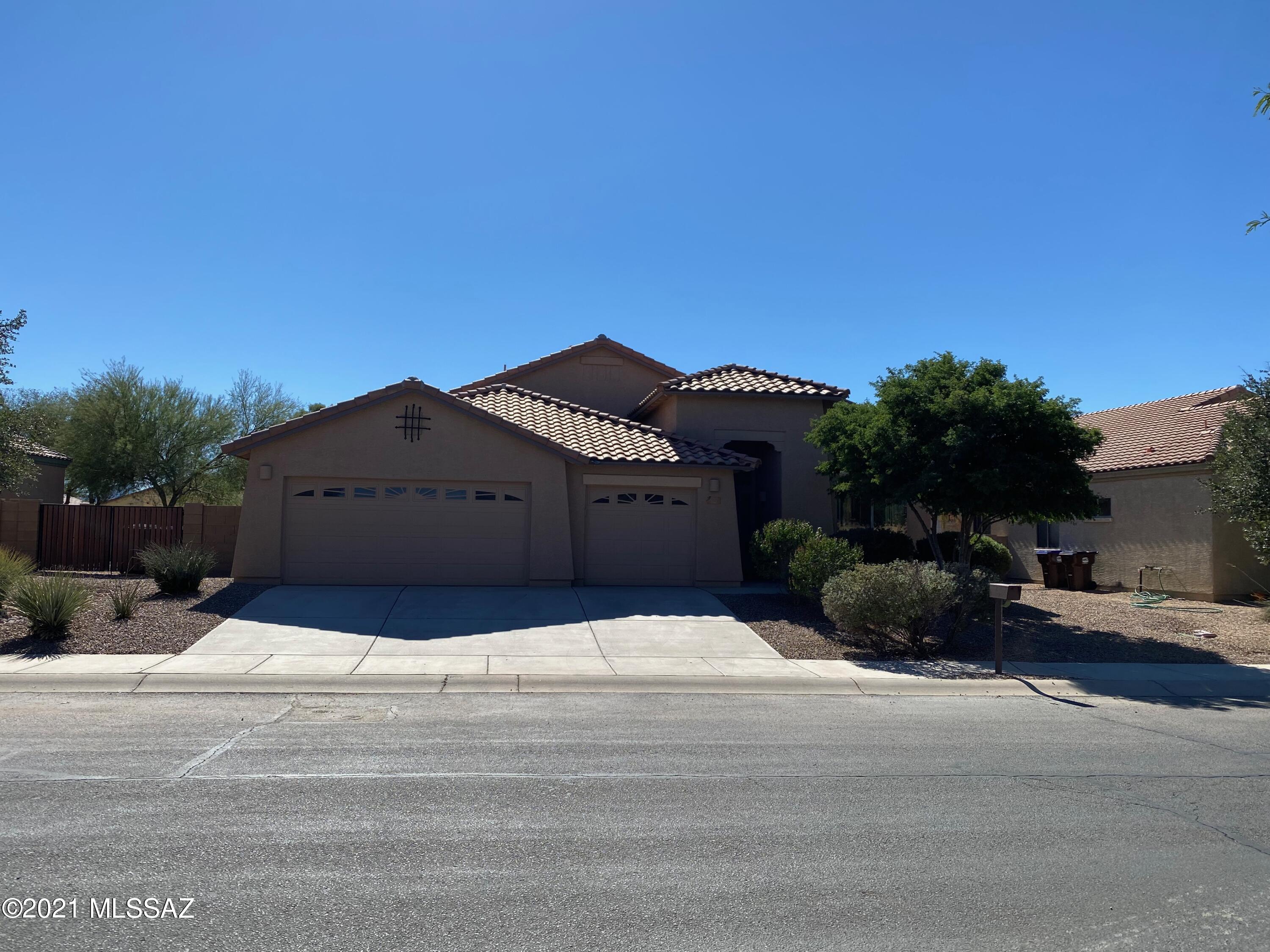 This open concept floor plan has it all!  Located in the growing NW Tucson area with all the amenities you want and need in a spacious 3 bedroom 2 bath home, AND a 3 car wide garage with epoxy floors ready for you.Features include: split bedrooms, living/dining/large breakfast bar plus a large bonus flex space for a pool table, teen space etc. Main suite w/garden tub and separate shower, double sinks and walk in closet. The kitchen is at the heart of the space and opens to all the spaces, with plenty of cabinets ,large pantry, high ceilings, fans, plant shelves, designer niches and much more . The huge backyard has double gates on both sides and reclaimed water for irrigation.  Comfortable layout will ensure a feeling of ''home'' for years to come. Parks and open grassy spaces steps away!
