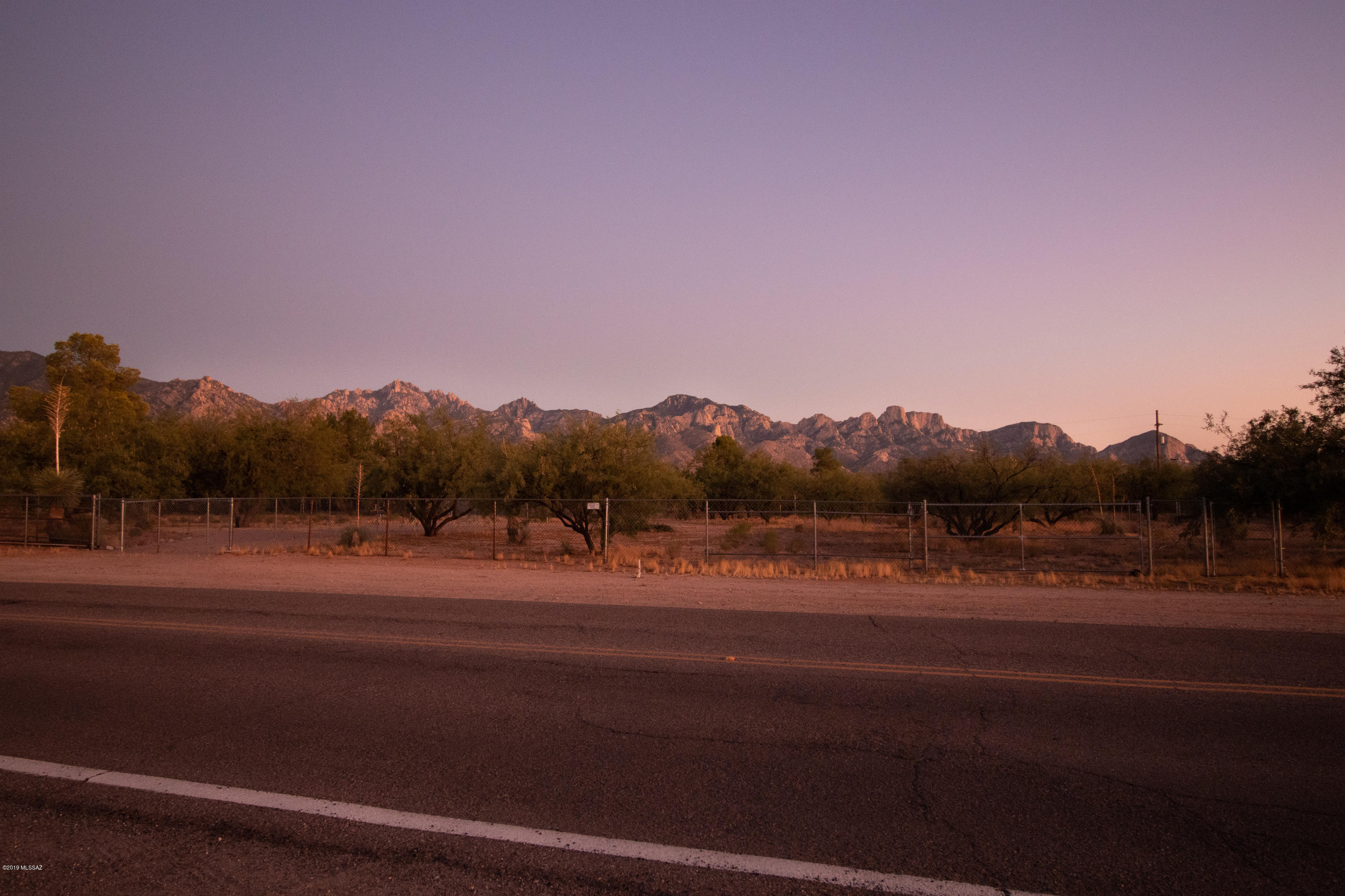 Beautiful fenced flat parcel ready for your dream home. Wonderful build site right off the paved road. Only 10 minutes from Tucson. This wonderful flat lot has mountain views and easy access to Catalina State Park riding trails.  Manufactured or stick built homes.