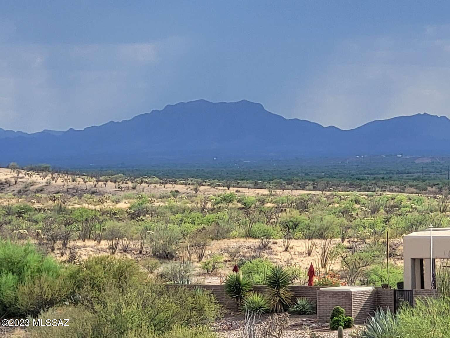 This desirable, elevated, 1.92-acre, interior lot on a cul-de-sac in the upscale Colonial Real subdivision features a view of four mountain ranges during the day and the lights of the Green Valley basin at night. The four corners of the lot have registered land surveyor medallions and white PVC poles with silver tape and orange flagging at the top. The approximate corners of the potential building envelope within the lot boundaries are marked with orange flagging at the top of 5 ft PVC poles. At the northeast corner of that envelope is an elevated and gently sloping building site with excellent views and easy driveway access.