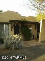 Cute Sante Fe style townhome! Great for investor, first time buyer or retirement home. Open and spacious with a beehive fireplace! Kitchen is quite large with plenty of room for a kitchen table! Private fenced back yard! Covered parking right in front of your unit, lots of storage and a community pool for Tucson's hot summer days! HOA includes water, trash, pool, landscaping, common areas and blanket insurance