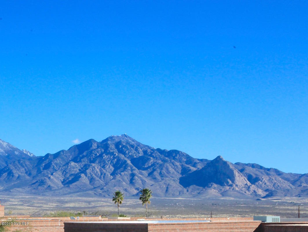 Enjoy breakfast on the patio and take in the beauty of the Santa Rita Mountains! This 1750 SqFt townhome is in absolutely move in condition! Fully furnished with a Southwest flair; this home has 2 Baths, 2 BR, Plus Den. Kitchen has plenty of space to move freely and beautiful composite counters & stainless appliances. Ceramic floors throughout, even under carpet in bedrooms and den! Corner brick gas lot fireplace in living room creates a cozy atmosphere. Don't miss seeing this home... it is wonderful.