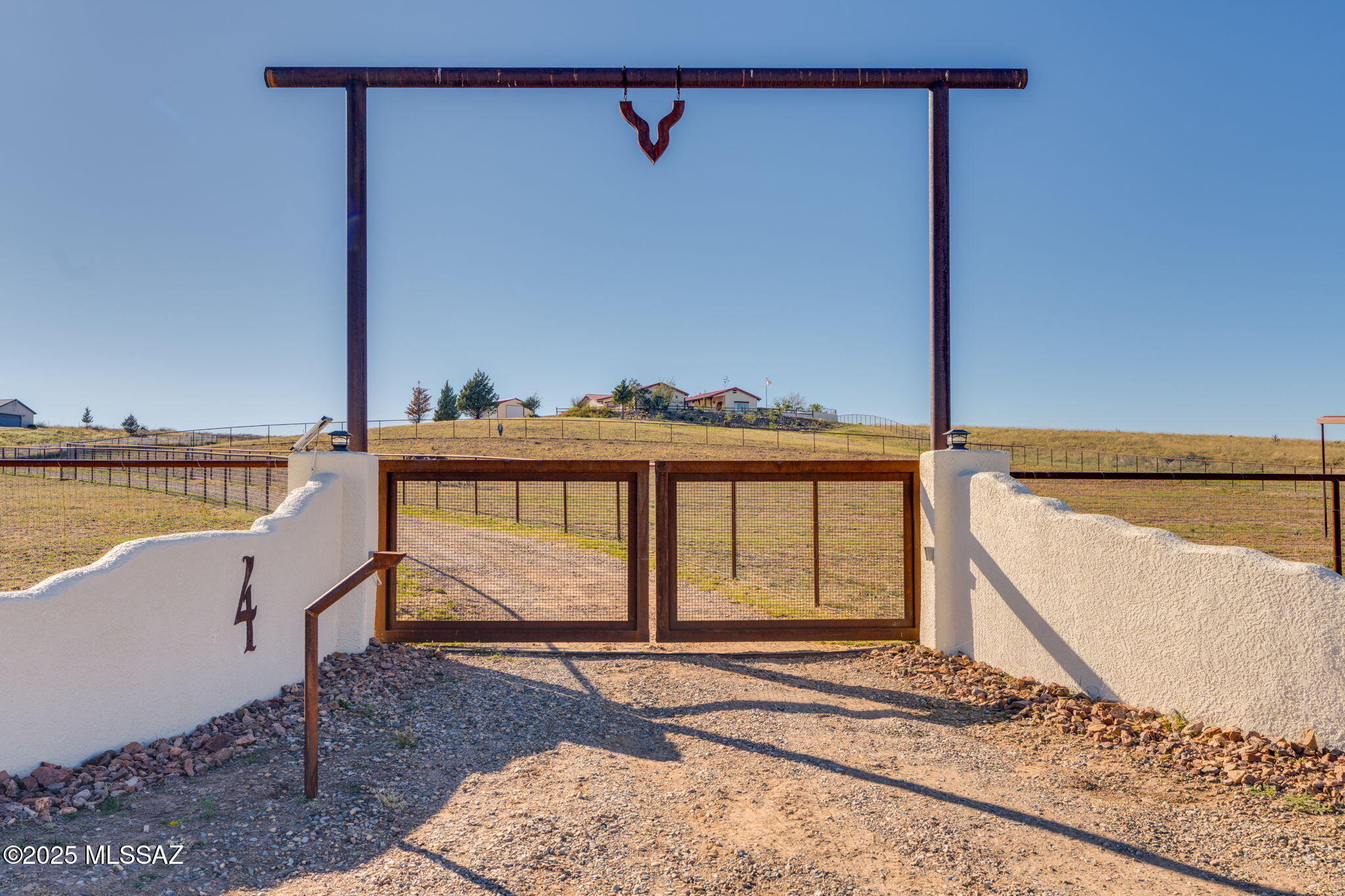 Do you dream of a custom luxury home paired with an amazing equestrian facility?  Located In Sonoita, in the heart of Arizona's stunning wine country,  the high-desert elevation of nearly 5,000 feet gifts you a perfect climate with mild summers that rarely exceed 100 degrees.  With panoramic views for days across rolling grasslands and majestic mountain ranges, welcome to 4 Mustang Trail. This exquisite 3-bedroom, 3-bathroom stunner is a rare find, perfectly positioned on 8+ acres and offering a masterful blend of refined living and a professional-grade horse property.  From the dedicated 40x60 horse stalls to the 5 fully fenced acres with top rail no climb the property also shows off its massive 20x25 custom shop.

4 Mustang Trail has been meticulously designed for those who appreciate space, custom craftsmanship, and the freedom of rural living without sacrificing convenience.This beautifully designed three-bedroom, three-bath custom home blends timeless architecture with inviting comfort. At the heart of the property lies a serene courtyard, complete with a bubbling fountain  the perfect setting for morning coffee or evening gatherings under the stars.

Inside, an open great-room design creates a bright, spacious flow ideal for entertaining or relaxing. High ceilings, rich finishes, and thoughtfully placed windows enhance the sense of warmth and light throughout. A private library nook offers a quiet retreat for reading or reflection, adding to the home's refined yet welcoming atmosphere.

This incredible  back yard was designed for year-round entertaining. The area seamlessly extends your home's footprint, providing the perfect setting for relaxing evenings or large gatherings.

For the hobbyist or collector, not only does this home have a three car garage but also has a substantial 20x25 shop with custom shelving that offers secure storage, a dedicated workspace, or a haven for your projects. This 20x25 shop is wired with three 110 circuits and one 220 circuit,  (the 220 is wired  but not hooked up). In addition, the property is equipped with dedicated, easily accessible RV/boat parking, ensuring all your toys and equipment have a safe, organized home. 

With amazing location, cooler temperatures, a gorgeous welcoming home and amenities to fit most any hobby, what are you waiting for?