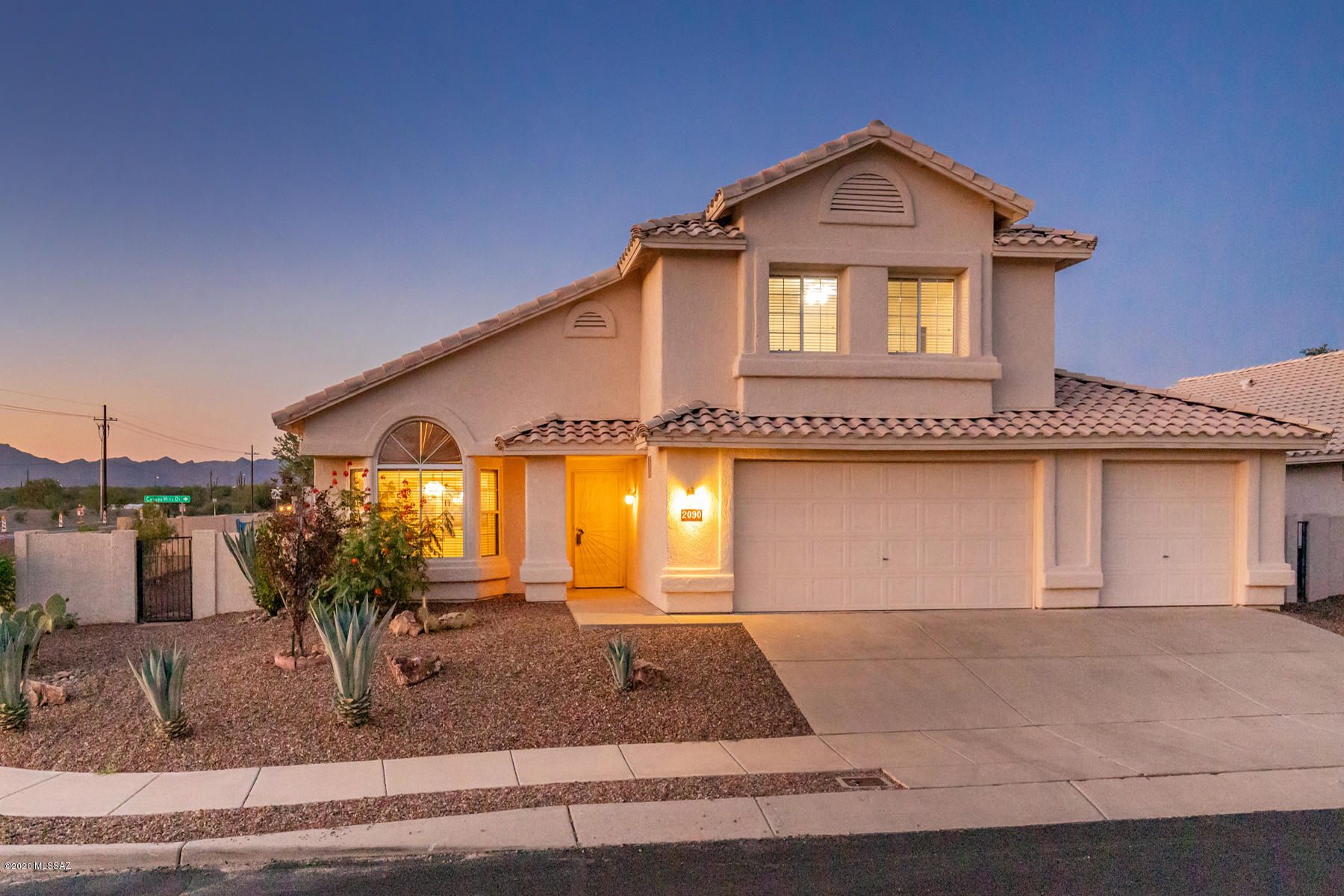 Tucked away on a tree-lined street in a quiet neighborhood in the heart of Oro Valley, with wonderful views of the Tortolita and Santa Catalina mountains, this spacious, well-maintained and freshly painted 4 bedroom home has plenty of space for everyone. Mature landscaping greets visitors who enter the granite-floored entry. A large living room has a bay window, comfortable sitting areas and even room for a piano. The well-lit dining space can expand for room for all at the holiday table. Art niches are featured in the hallway. The excellent kitchen has abundant granite counters, pull-outs in the lower cabinets, a separate pantry and a five-burner gas stove, while the adjacent breakfast nook overlooks the sparkling pool. This opens to the large family room with a handsome fireplace for our chilly desert evenings, room for multiple seating areas and even for a pool table.  A large downstairs bedroom enjoys double closets with full separate bath and linen closet adjacent. Upstairs, the generously sized master bedroom enjoys a private balcony with views of the Tortolita Mountain Range and also views of Pusch Ridge from the windows. A master bath features a walk-in closet, tub/shower, double sinks and a separate toilet. Two additional large bedrooms share a third full bath with a make-up counter. The three-car garage has room for storage and an extra refrigerator if desired. The main public areas of this lovely home are large ceramic tiles, easily maintained, while handsome carpeting in excellent condition is featured in the bedrooms and on the stairs. Outside, enjoy an oversized covered terrace area for enjoying margaritas by the pool. The oversized rear yard has citrus tress and room for a play structure. The neighborhood could not be better, with easy access to Oro Valley's wonderful restaurants, personal and medical services (Oro Valley Hospital and Northwest Tucson Medical Center are both easily accessible), excellent schools, a nearby golf course and quick access to downtown Tucson. Please call for you private showing of this warm and welcoming home today.