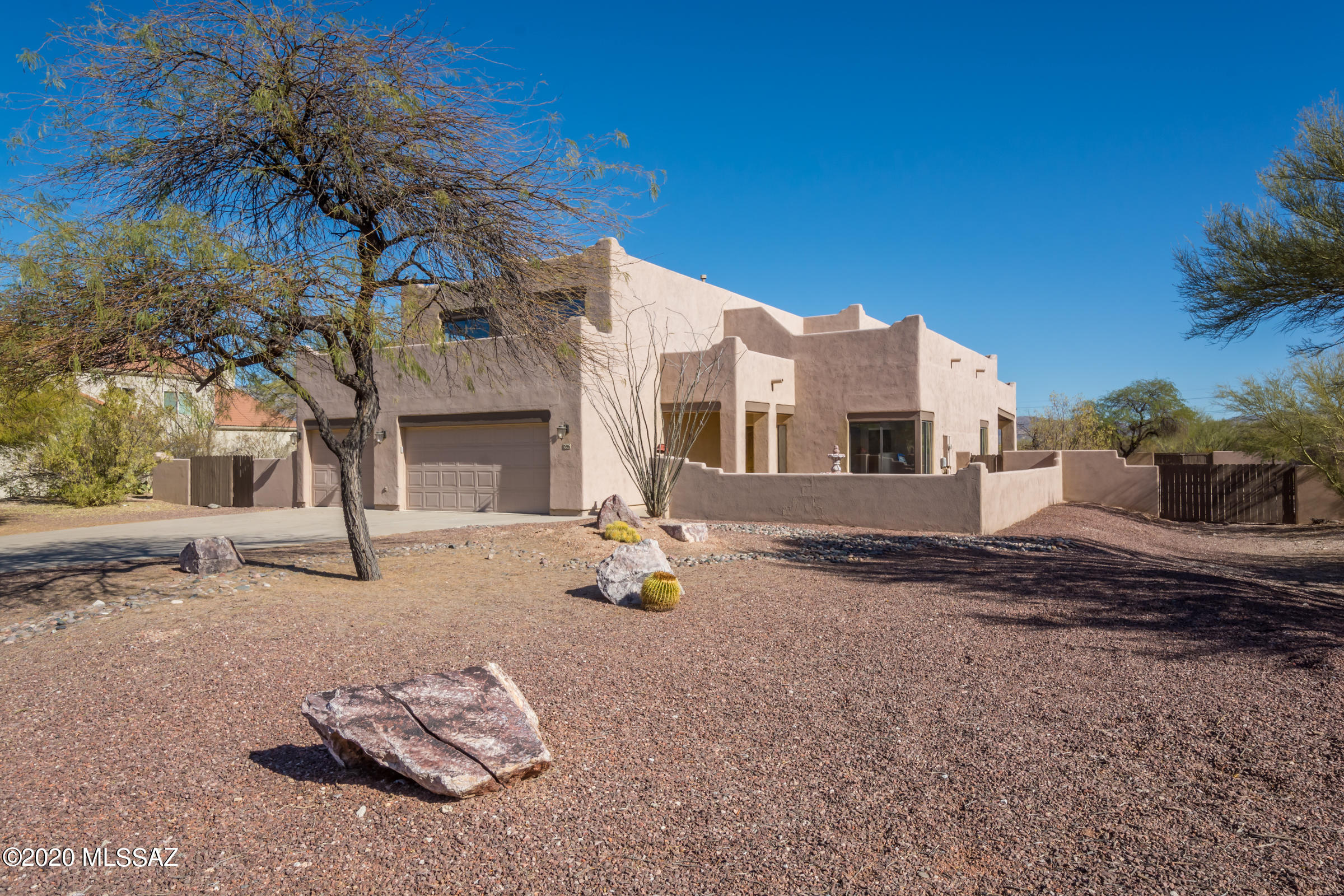 Fantastic East side home in the private, gated Community of Arizona Estates. Custom home on almost an acre features charming front courtyard, spacious living/dining room, Kitchen overlooks the huge Family Room with fireplace, Bfast bar island, Walk In Pantry & lots of cabinets. 1 BR/Bath on 1st floor, upstairs  enjoy spacious Master Suite with private Balcony overlooking the rear yard w/panoramic Mountain Views. Enjoy the updated Master Bath with large shower & sep tub. 3 additional large bedrooms and Guest Bath upstairs.  Front bedroom deck with amazing views. 3 Car Garage & huge laundry room will accommodate today's Washers/Dryers! Large covered patio, extended patio and back yard is fenced with gates on both sides-ready for your pool & landscaping to make it your private paradise!