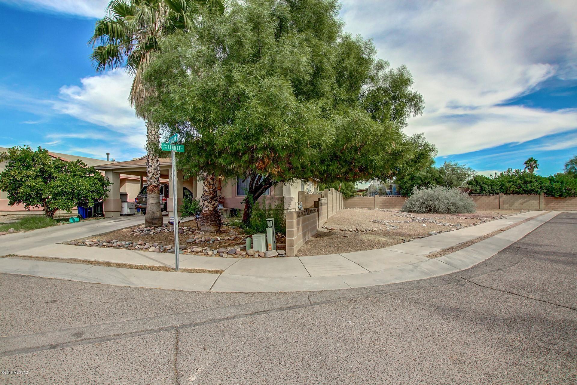 Nestled on a corner lot with plenty of shade trees. Charming single level Home with soaring ceilings, soothing palette, neutral tile floor, ceiling fans, and open floor plan. Granite kitchen counters, patio access, white appliances, breakfast bar, and wood cabinets with hardware. Generous size bedrooms, ample closets, and 2 baths. Bring your imagination and creativity to make this Home your own!! The backyard with covered patio is a blank canvas for your future desert oasis.