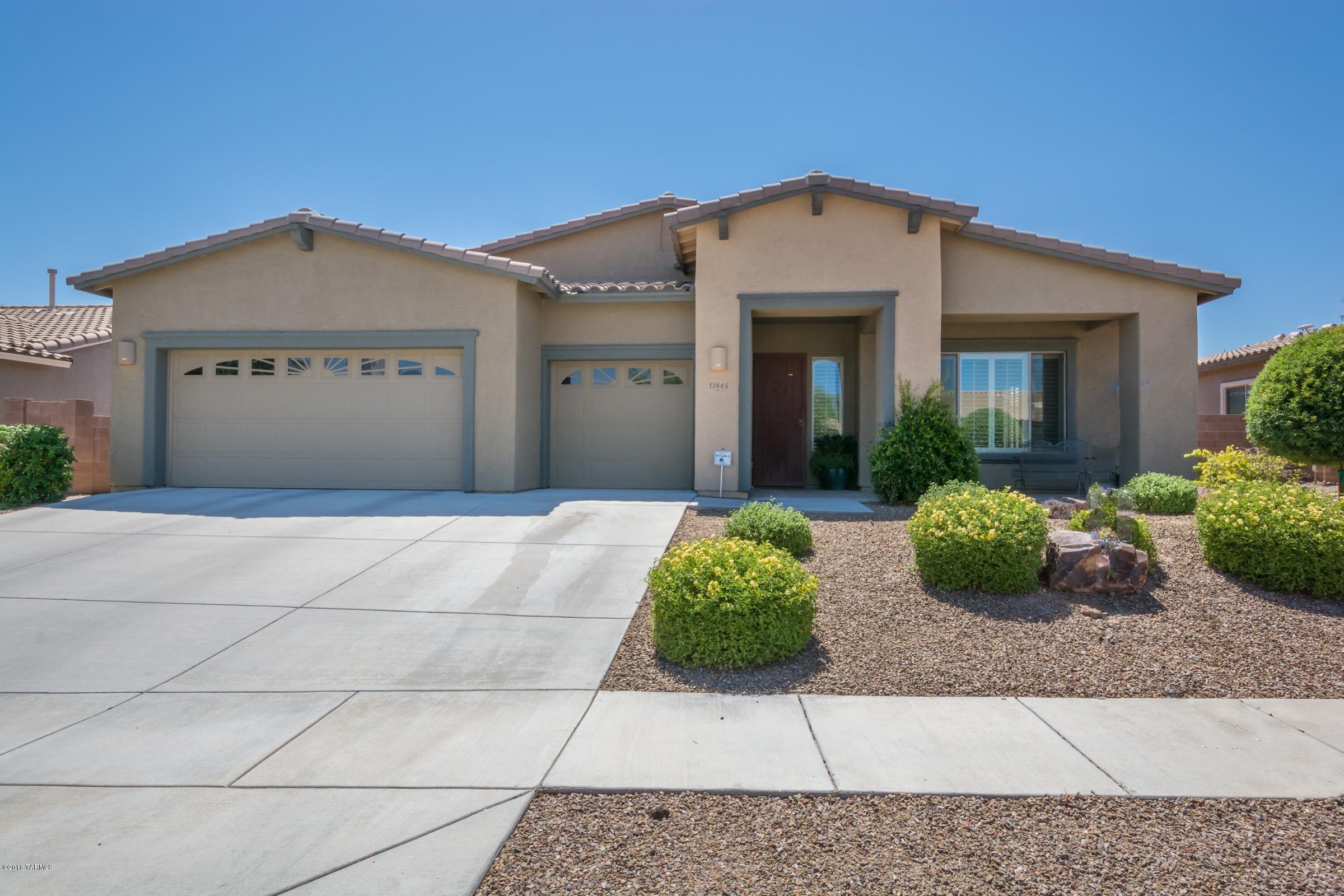 Gorgeous 5 bdrm/3 ba home w/fantastic Monterey Home floorplan & 3 car garage Custom 18 tile. Granite slab counter top in Kitchen,& NEW designer glass backsplash. NEW SS appliances including side by side refrigerator. NEW interior paint throughout. Custom walk in tile shower in 3rd bath. Sit on front porch & be in awe of the majestic view of Pusch Ridge Mtn. Beautiful backyard feels like paradise. Oversized pool & spa, putting green, bbq area & covered patio making outside extension of home. Newer exterior paint, newer garage door and pool heater.