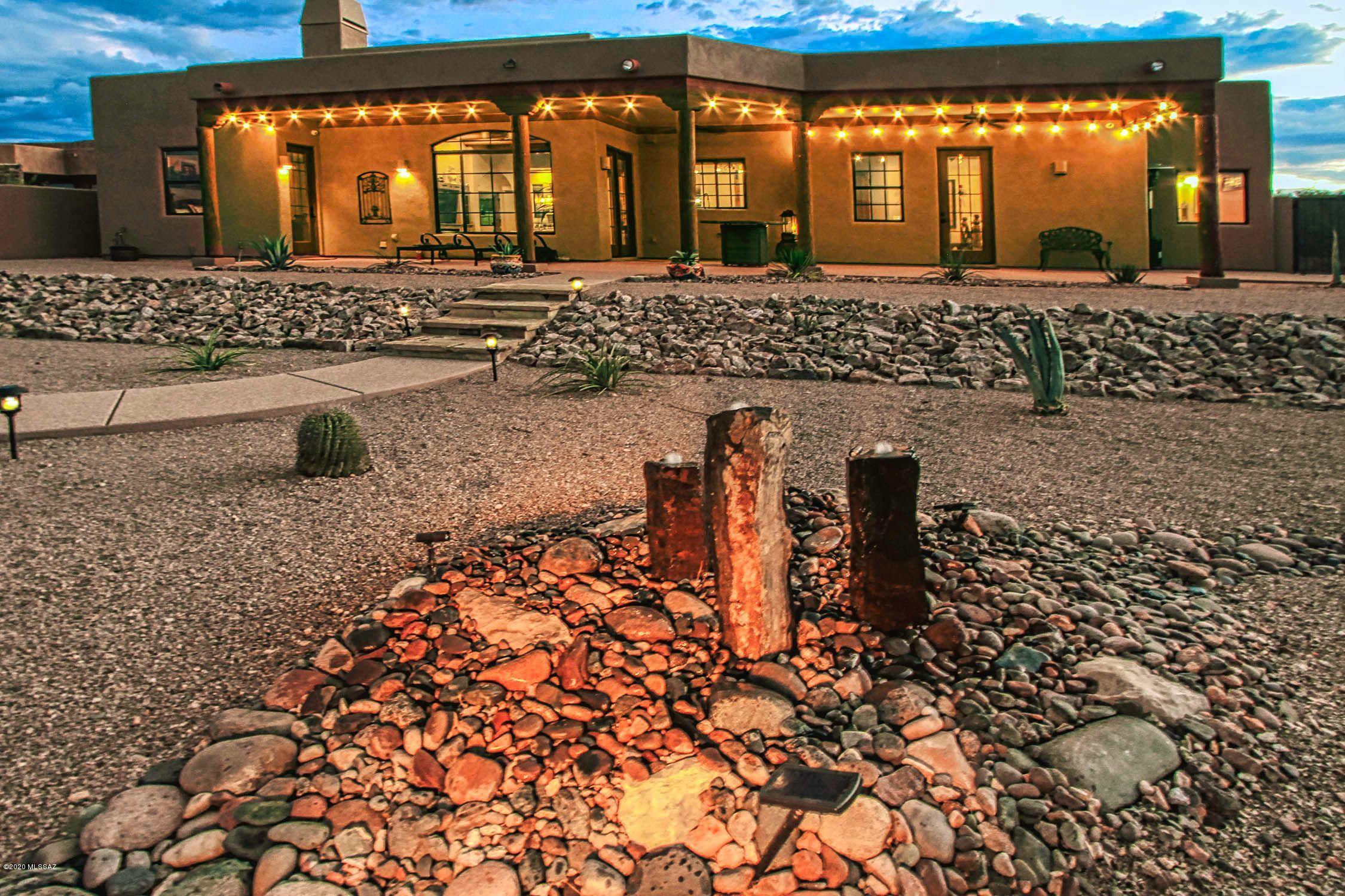 Range  priced- Owner will accept or counter offers in the range of $565,000 to $590,000. Custom Like New Southwest Territorial Style Custom home. on 1.28-acre home site with unobstructed Rincon Mtn views. Home features soaring 12 foot ceilings with Viga Beams, fabulous granite/stainless steel kitchen with Alder cabinets &, Mesquite wood bar plus formal dining, 8 foot Alder doors, cozy fireplace, oversize 3 car gar, soft water loop and more. Lovely Master Suite dual vanities, walk in closet, walk in shower, soaking tub and extra space office or workout.  Large laundry with custom cabinets, and 2 kitchen pantries. Attached guest quarters with living room, kitchenette, bedroom, bath walk in shower. Delightful outdoor spaces front and back with covered patios path solar lighting and water features. Very private setting and quality throughout home.  New landscaping throughout and cozy paver brick patio in enclosed front courtyard.  Home is very special and ready for you now.  Call to schedule your private tour!