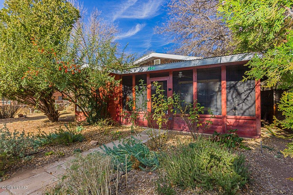 PATAGONIA COUNTRY COTTAGE w/ RENTAL UNIT ON 1.5 LOTS.  Loaded with Patagonia charm, this remodeled home is either a 3Bd/2Ba home with large bonus room, or a 2Bd/1Ba owners' unit and separate 1Bd/1Ba vacation rental with its own separate entrance.  Current owner remodeled and created the rental unit which provided over $12,000 in income in 2017. Located in a great location, just steps from everything in town. 1.5 town lots with room to expand and lovely gardens.  There's even an old barn and workshop. Home is on a private well (great for gardening!)but with ability to hook up to Town water. Large kitchen, custom cabinetry, separate dining room, and charming screened porch. Perfect for bird-watchers with bird-friendly habitats, trees & plants.