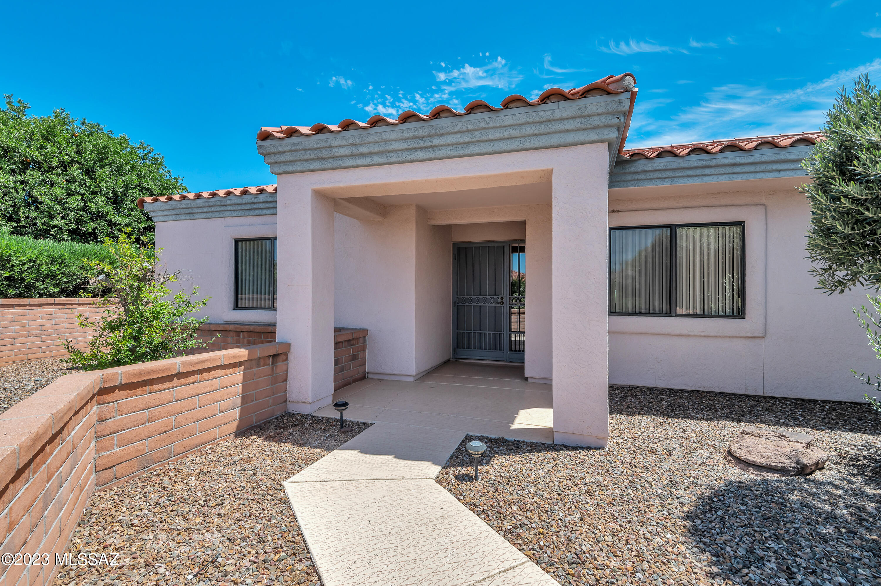 Well-loved and well-maintained home. Here is your chance to be on San Ignacio Golf course in San Ignacio Ridge Estates. Let your creative juices flow with this back yard and any updates inside that you would love. Primary bedroom and ensuite are on the back of the house with access to the back patio. A pocket door leading into the guest bath and bedroom provides privacy for your guests. The front room, which is currently a conversation area is adjacent to the dining room. There is a wall, for separation between the front room and family room. Enjoy this large and open kitchen with a breakfast bar and casual dining area. Off the kitchen is an office area along with a large laundry room. Step outside onto the partially covered back patio with pavers, great views of the Santa Rita Mountains and the golf course. The possibilities are endless here. Lots of room for a pool! 2 car garage with attached storage cabinets. Furniture and furnishings available by SBOS