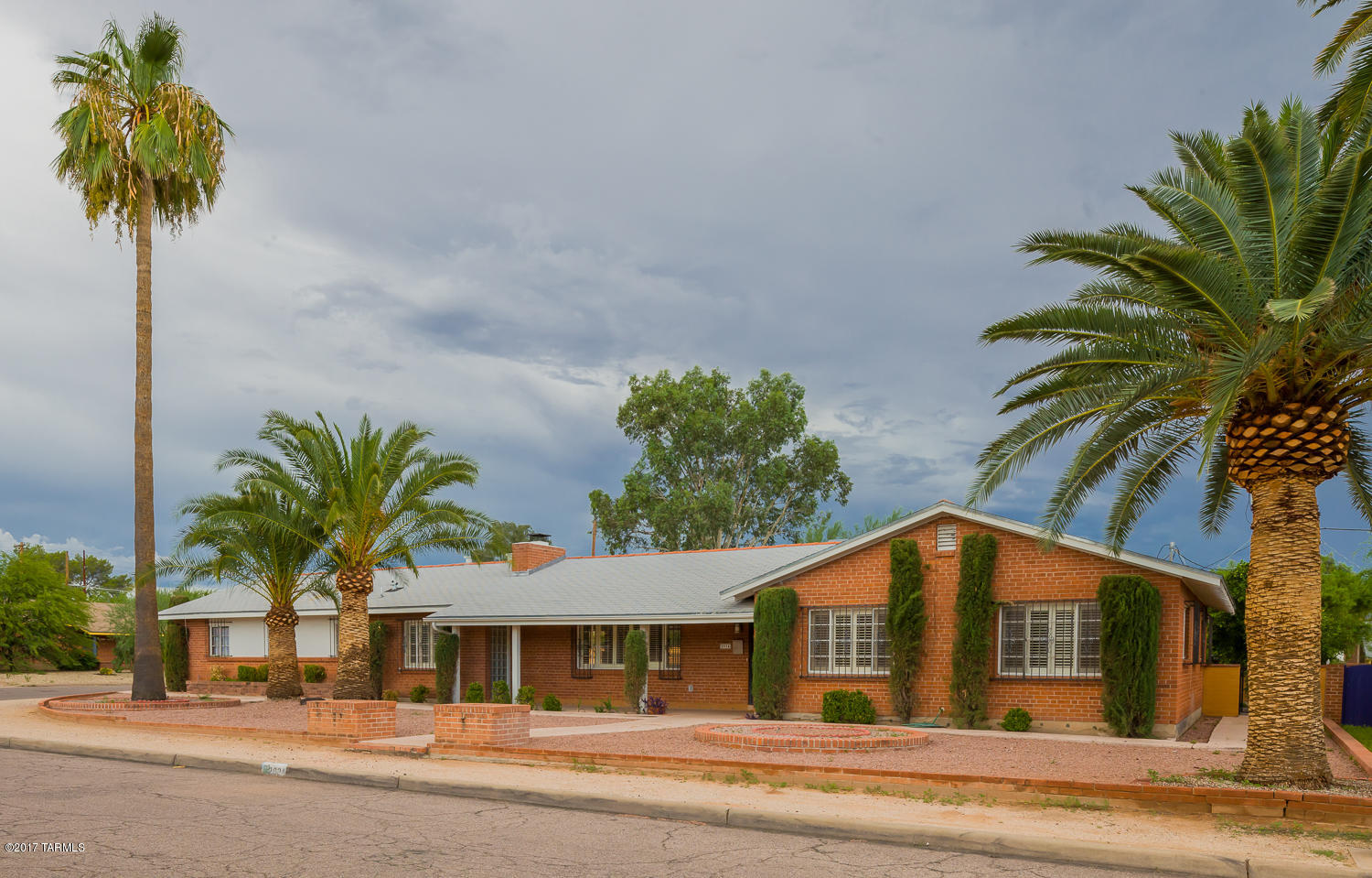 You have been waiting for this updated U of A area home, located in the heart of one of Tucson's most popular neighborhoods, Broadmoor. Built by craftsmen in 1951, the wire cut red brick home retains its beauty and integrity to this day. Inside, you will find a spacious living room with big fireplace and a south facing wall of windows that look to the huge covered patio, pool, and unfinished guest house/studio. The block wall secures your privacy. The outstanding kitchen, boasts modern cabinets and appliances plus a chef's 5 burner gas stove, and a unique tin ceiling. Kitchen-side is a spacious office and 3/4 bath. On the west wing, past the full (original tiled) hall bath, the 3 bedrooms are generous,one sports a full bath. The big 3 car carport and storage top it off! This is a must see!