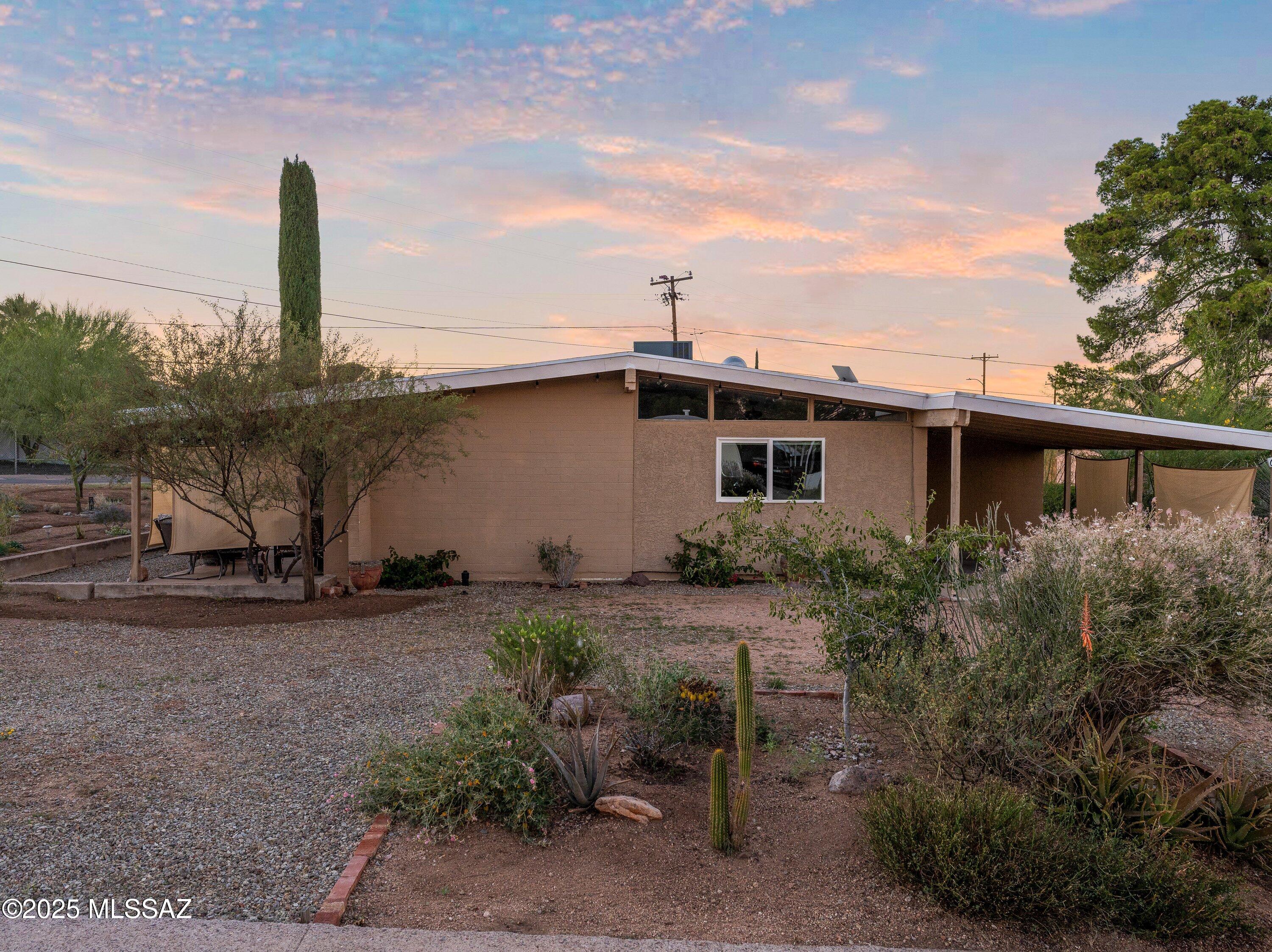 Welcome to this beautifully preserved mid-century modern desert bungalow, designed and built by the iconic Del Webb company in 1954.Situated on a spacious corner lot with sweeping mountain views and additional parking. This beautifully restored home blends classic design with thoughtful modern updates. A highlight of the property is the newly established pollinator garden featuring over 100 native trees and drought-tolerant plants. Fully restored in 2019, the home boasts a suite of updates including: a newer AC unit,tankless water heater, composite roof,double pane windows and sliding doors, updated electrical wiring, plumbing,sewer line coating, and drywall. Nestled in the serene San Pedro River Valley, this gem is located within the historic mining village of San Manuel, near the base of scenic Mount Lemmonjust 30 minutes from Oro Valley and 45 miles from downtown Tucson. Whether you're seeking tranquility, sustainability, or a closer connection to nature, this meticulously updated home offers it all. Don't miss your chance to own a piece of Arizona history in this botanical desert retreat.