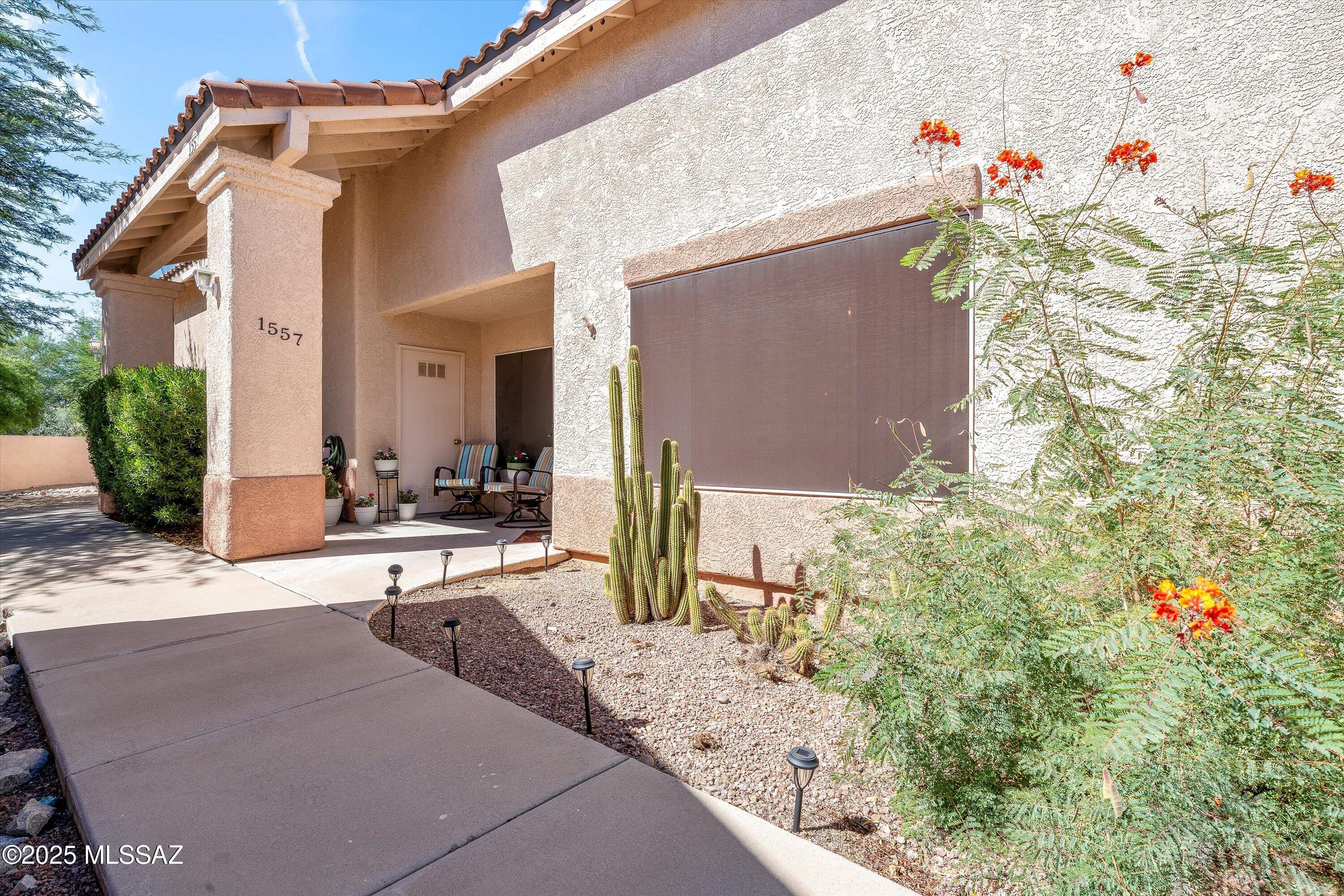 This elegant 2 bedroom, 2 bathroom Townhouse  is an exceptional turn-key opportunity. Located in a NON-AGE RESTRICTED community with GVR optional.  Bright and spacious end unit with split bedrooms, each with its own walk-in closet. The kitchen boasts abundant counter space and cabinets. Skylights and oversized windows fill the home with natural light, accentuating the 9' ceilings. Enjoy enclosed patio year-round.  You'll appreciate the assigned carport space, nearby I-19 access, shopping and dining.