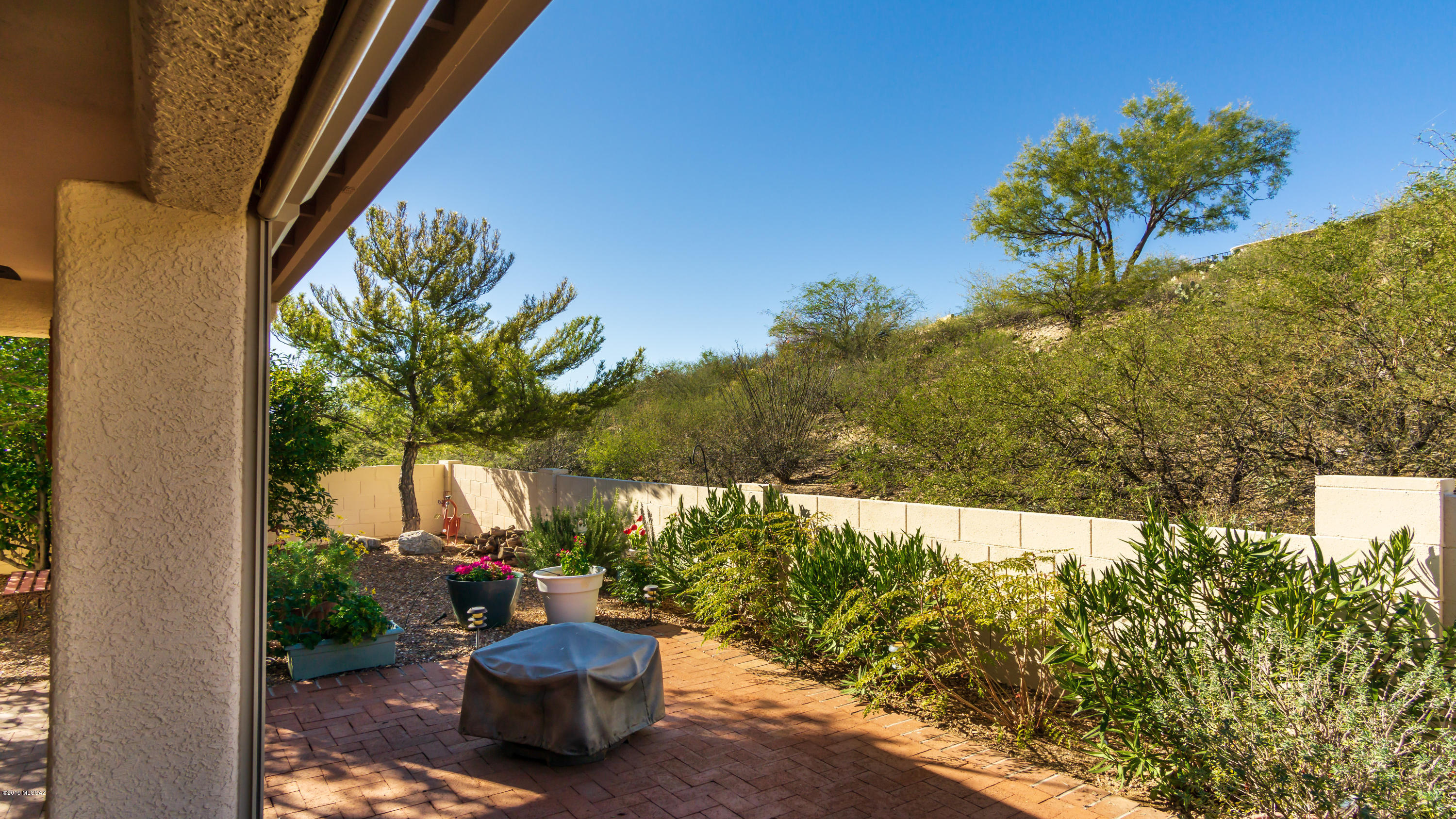 Enjoy your own private patio & peaceful backyard, while watching local wildlife pass by! This well maintained Diego model is sited above street level & affords awesome mountain views. A comfortable living/multi-purpose room leads to the open kitchen/family room, which looks out on the lovely landscaped backyard with soothing rock water feature & natural green space beyond. Two spacious bedrooms, two full baths & a roomy office/den. This home also contains a large laundry/hobby room, plus a 2 full car garage with plenty of built-in storage cabinets & a workbench. Electric rolling sun shades on patio. Newly added amenities/features include: HVAC system, hot water heater, garbage disposal, irrigation/drip system, kitchen pull outs and faucet, plus the patio roof has been re-sealed.