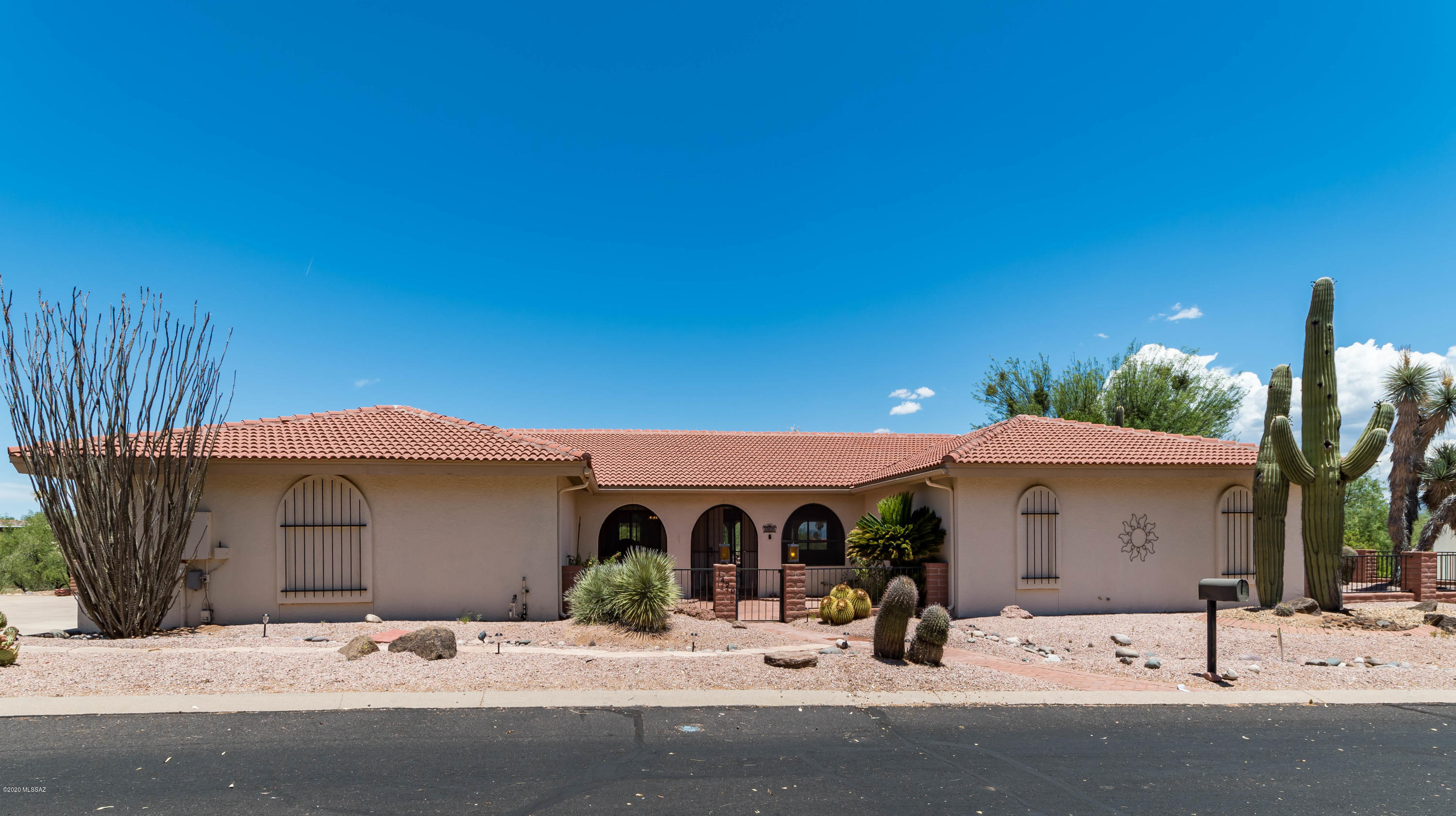 BONUS: $2,500 allowance to personalize your new home! Don't miss this custom home that offers fantastic indoor and outdoor space. The outdoor space boost Italian tile patios with wrap around verandas & enjoy breathtaking views of the Santa Rita Mtns from this private hillside home situated on 3/4 of an acre, cul-de-sac lot. Enter home through the double doors that lead you into large living room which includes, wet bar, built in shelves and beehive gas and wood burning fireplace. The home features split floor plan and bathroom attached to each room with an additional half bath. The master retreat features a large walk-in closet, dual vanities, separate tub and shower.  Extended garage has storage cabinets and storage room.