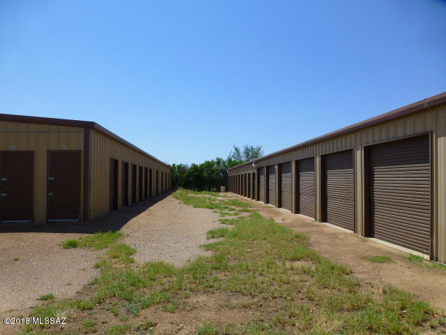 Great opportunity, high visibility off HWY 191 in the Elfrida area.   110 metal storage units. Two large metal shops, one is 2000 sq. foot shop with an auto paint booth, 4 garage doors and the other is 2400 sq. ft. w/ two tall garage doors.  Personal residence built in 1973 is a 2665 sq. ft. brick home, 4 BD 2 BA, 4 car carport, food storage, new furnace, new water and gas lines in the home.   Travertine tile throughout the home.  Storage units (33) 10 x 20 {$80}, (12) 5 X 7 {$30}, (25) 10 X 10 {$50}, (10) 10 X 14 {$70}, (30) 8 X 10 {$40}, total SQ FT equals 13320, (this does not include the 2 large shops). Twenty eight units are currently rented. Needs local management to reach its full potential. All this on 11 acres, eight acres north of back shop are vacant. Buyer to verify sq. footage