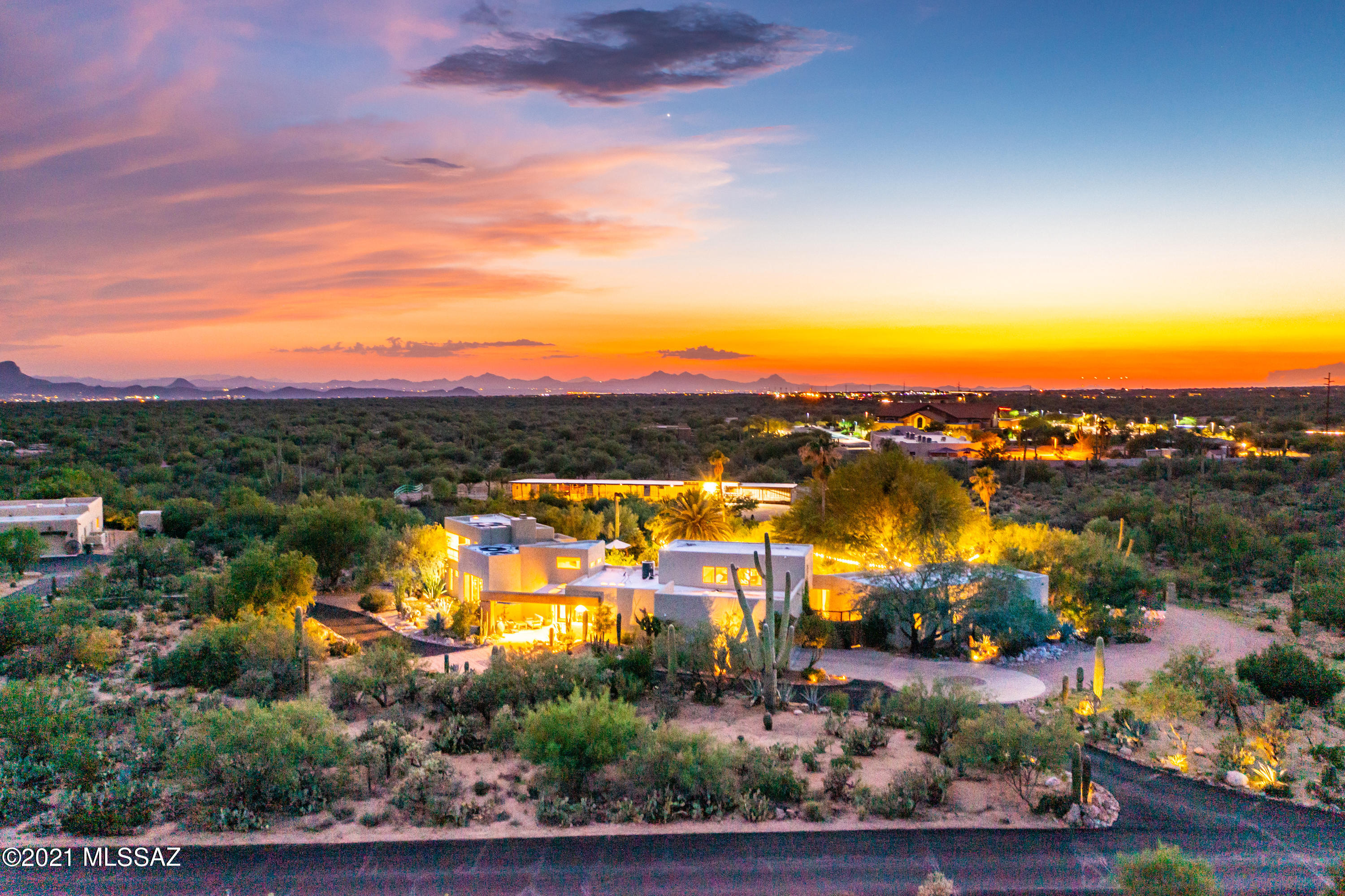 Magical! Breathtaking walled grounds with stunning, inviting 4,178 SF home and 1,095 SF Guest House plus horse barn & pasture, extra garage and RV hookup on 5 park-like acres in the heart of Oro Valley. Serene views in all directions including Catalina Mountains from kitchen and living areas plus fabulous sunset views. Stunning pool, spa, waterfall, gazebo and lush landscaping with giant agave and saguaro on 1 very private acre. Wide gates at south and north sides of property provide access to rear 4 acres with equestrian facilities and second oversized 2-car garage plus hay barn (2 circular drives). Private gated community of 8 properties in premium Oro Valley location near trails, schools, restaurants and shopping. You'll be awed by the charm and privacy of this 5-acre Paradise. Magical!