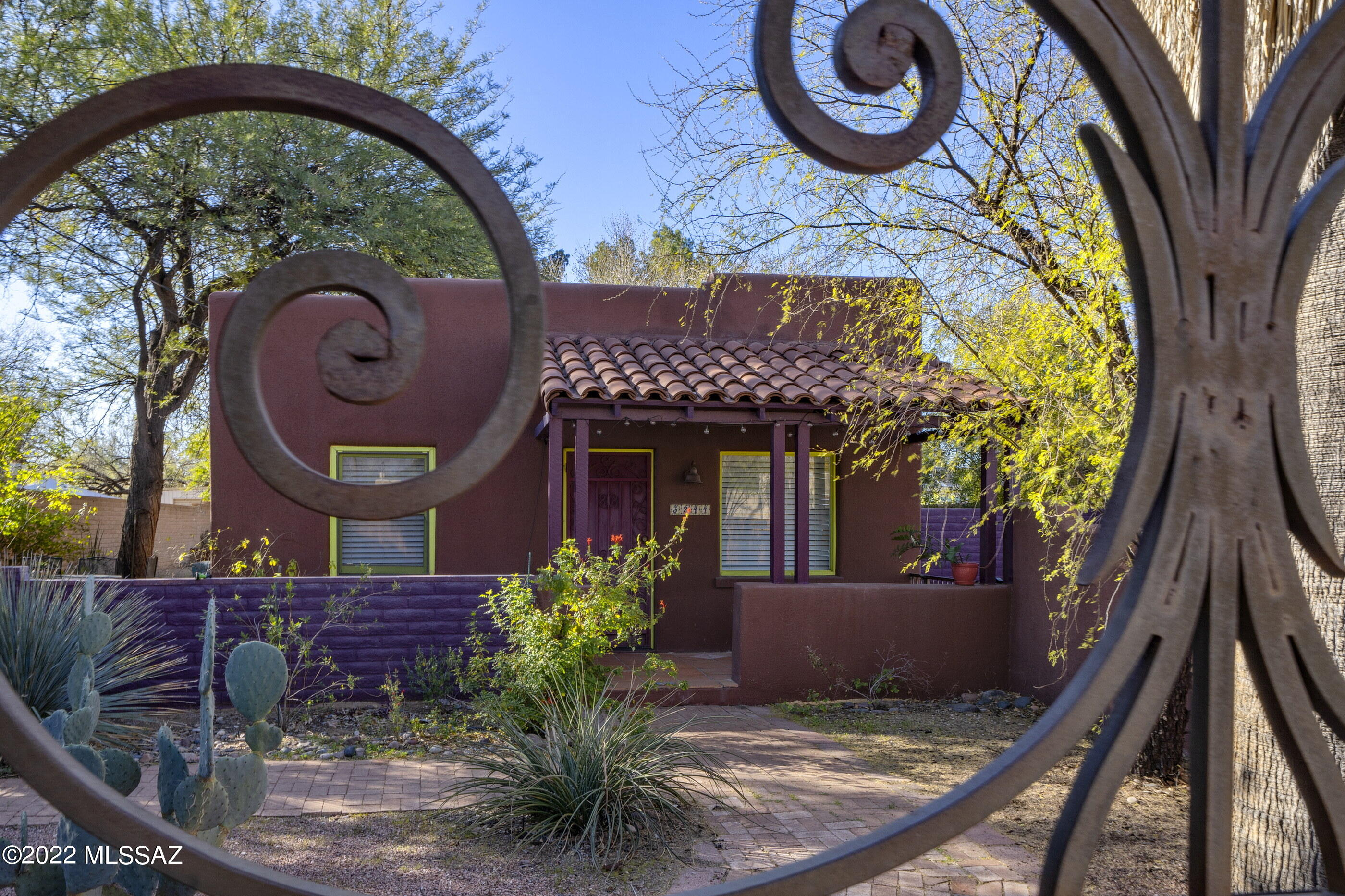 Adorable 1941 SOUTHWEST MUD ADOBE (1 BR + den + living & family rooms). BEAMED CEILINGS, polished concrete & Saltillo tile floors offer charm along with navy blue & white checkerboard tile. Bright & light with loads of color. Wonderfully updated kitchen with stainless steel appliances. 2017 AC, hotwater heater + new bathroom with a ''walk in'' shower. You will find a large storage shed in the huge back yard (irrigation system transfers as is). This delightful home is located minutes from UofA, UMC, restaurants, & stores. Long drive way will accommodate 2-3 cars (tandem). Sellers will look at offers priced betweent$300,000-$315,000 on Monday at 2 pm.