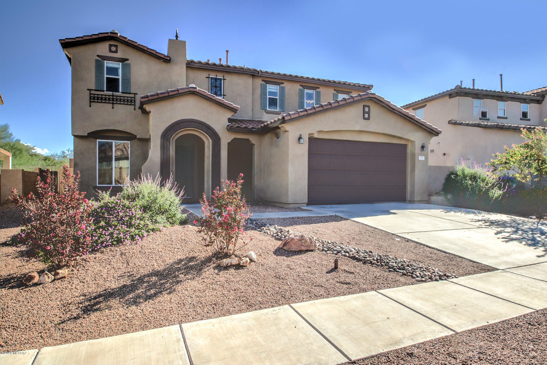 Fresh exterior painted two-story 5BD/3BA, two-car garage home located in ''Presidio del Cielo'' with ''NO'' rear neighbors, features 9ft ceilings, tile flooring and new carpet . Home welcomes to a formal living & dining area that is adjacent to an open space concept of kitchen & family room.  Kitchen offers Corian countertops, an extended breakfast bar, a breakfast eating area, spacious pantry & plenty of cabinetry space. Additional features include a hallway half bath & a bedroom. Upstairs, are four bedrooms, three with its perspective walk in closets, a hallway full bath with dual vanity, a shower/tub & a laundry room with built in shelves. A double door entry greets to a spacious Master Suite with a sitting area and large walk in closet with plenty of storage space, a double vanity, a garden tub & a walk in shower in master bath, plus endless mountain views. Enjoy your outdoor days under a covered patio & a large backyard waiting for your personal touch. Enjoy all the amenities that Rancho Sahuarita offers; from community parks/pools, walking/jogging paths, shopping & dining places, Sahuarita Lake, dog park, a club house & much more.