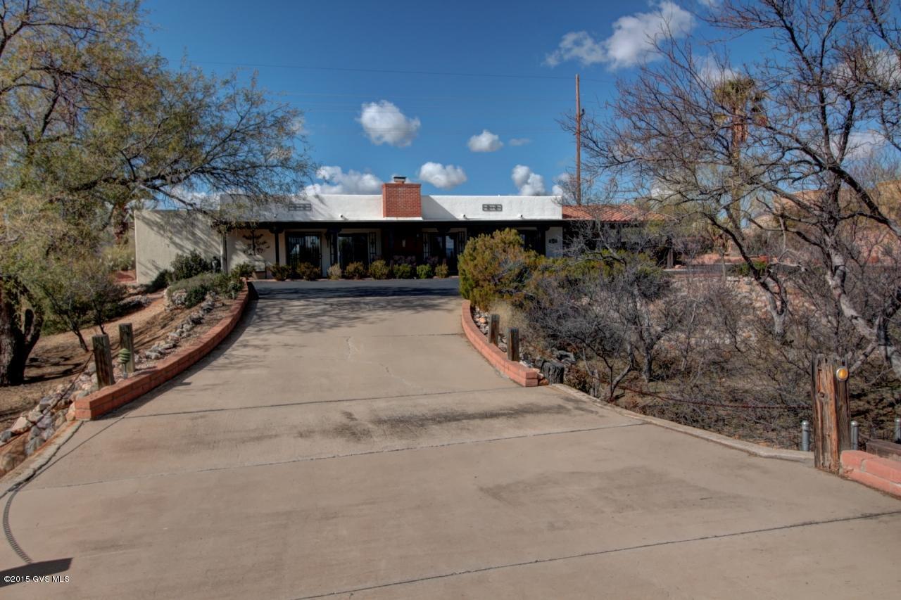 Stunning views of Santa Rita's in this spacious remodeled home with newer appliances, granite counter top, stunning large tile floors, formal dining room off large living room with beautiful fireplace. 3 bedrooms, plus an AZ room, large walk in closet and hobby room. Home has large private pool, and natural desert setting on all four sides, and an area on north side for RV parking.
 Active alarm system, lots of storage, shed with workshop, 1+ acre, NO HOA, NO Age restriction. 
 Privacy, wildlife but very close to activities and shopping.