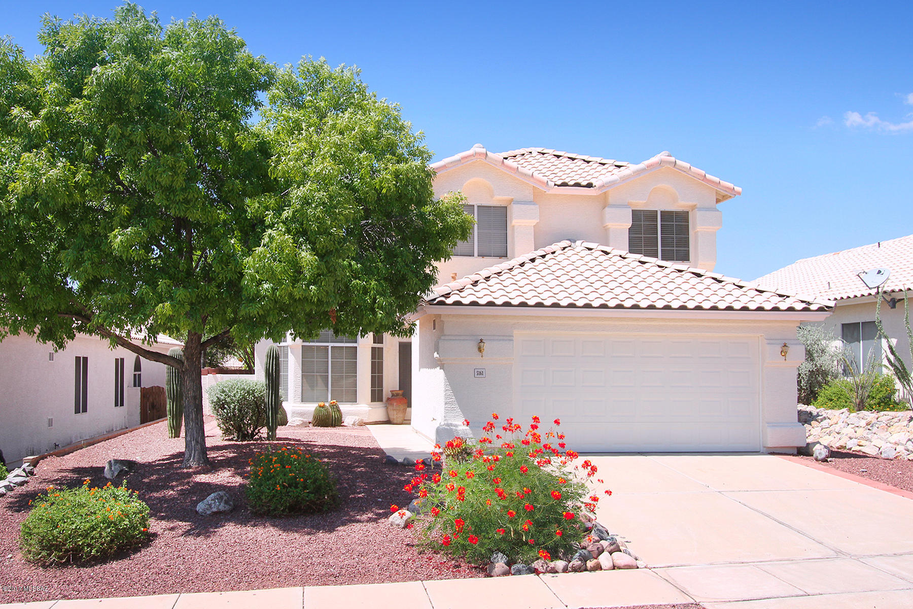 Located on a quiet cul-de-sac street, minutes from schools, shopping & Sabino Canyon.  This special home offers beautiful & practical wood plank laminate & tile flooring throughout entire 1st floor.  Vaulted ceilings & large oversized windows bring light & views inside.  Desireable floorplan provides 1 bedroom & bath on 1st floor.  The kitchen has been updated w/new stainless appliances, sink & countertops. The huge master suite provides a large, spa-like bathroom w/garden tub, separate shower, 2 sinks, vanity area & large organized walk-in closet.  A plank & beamed ceiling screened in porch offers additional space for living & entertaining privately screened by a yard edged in mature trees & shrubbery and a large pavered area perfect for BBQ's and get togethers.  Shows like a model!!!