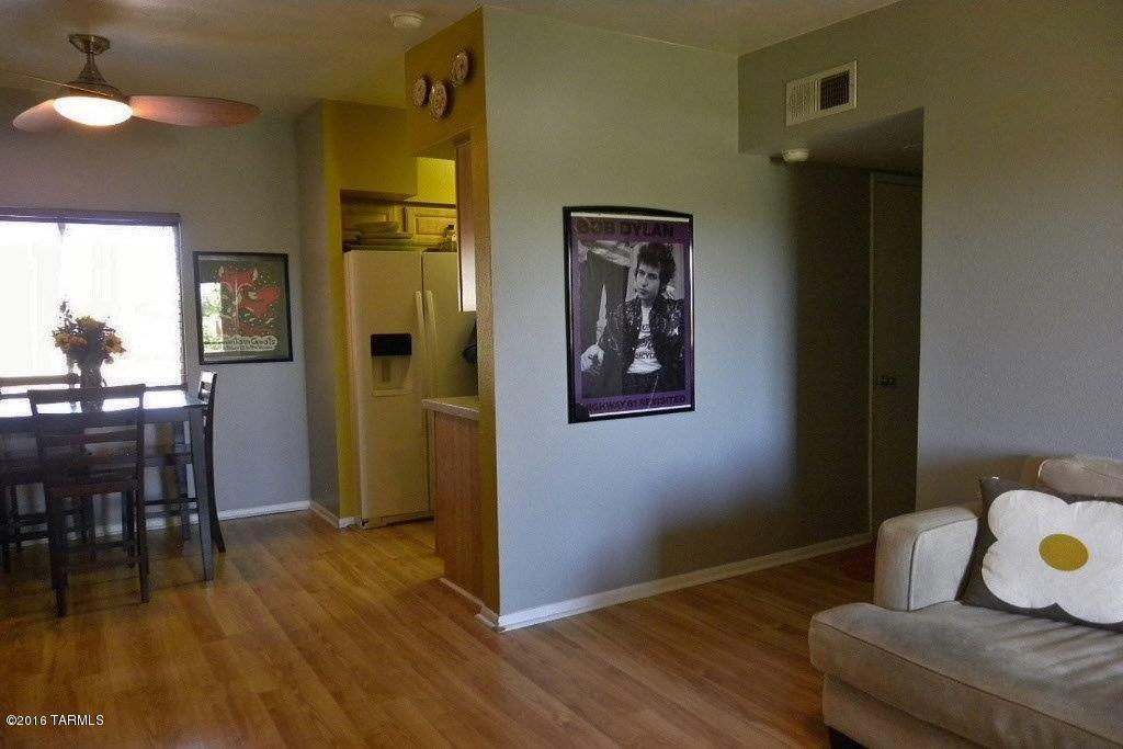 Rarely does a 2 bedroom, 2 bath come available in The Casa Club Condominiums and this unit is gorgeous! Kitchen has tile counter tops, built in microwave and refrigerator. Entire home has pergo floors and living room has a sliding glass door that goes out to the tiled patio with storage room. 2 bathrooms with updated cabinets and counter tops. Every room has a fan and brushed nickel finishes in both baths. Top floor unit in a gated community. Hurry, this home won't last long. Single story unit but unit is upstairs.