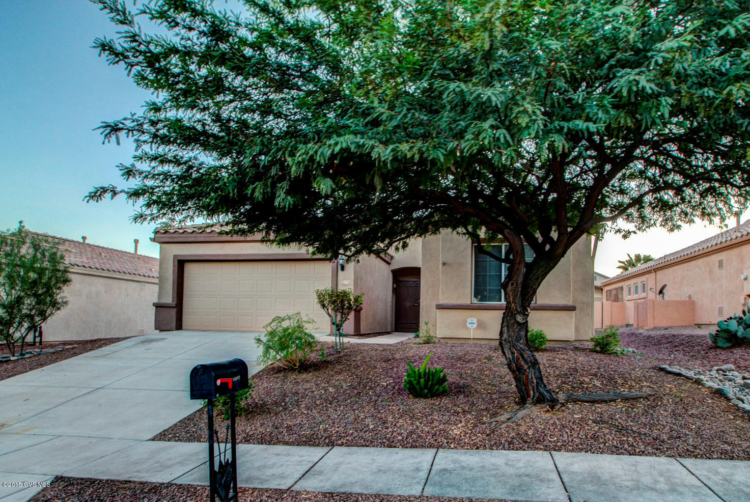 A beautiful Mesquite tree decorates the front yard of this lovely home in Desert Creek. Enter into a spacious great room featuring a gas log fireplace. The kitchen features a ceramic tile Island with a raised serving bar, gas range, an abundance of rich tone cabinetry with 2 large pantry cabinets and a convenient breakfast nook. It also has a built-in desk with an under-cabinet integrated file organizer to keep things in order. A large master bedroom offers space for a sitting area plus your bath provides decorative track lighting hovering over double vanities and natural light radiating through a glass block window. Catch up on your computer work in the office with built in cabinetry. A very large Arizona Room features a decorative concrete coating design and can be used for a variety  of purposes.