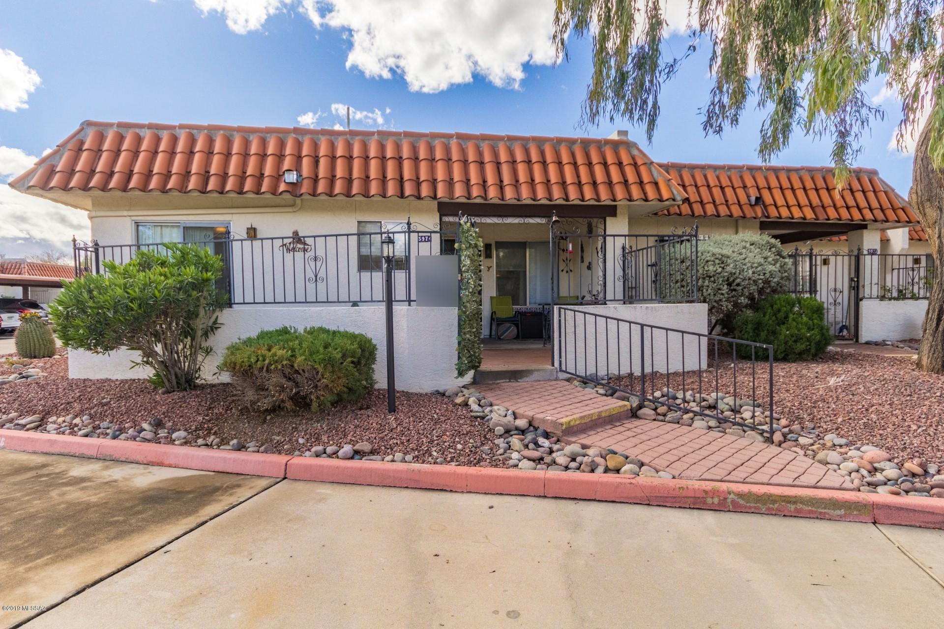 The best location in the development! Premium and private setting with large front entry patio, partially covered. End unit. North facing patio with mountain views. Lots of natural light! Large kitchen with extended sitting, dining area and sliding door to front entry patio! Living room has high ceilings and corner fireplace with upgraded carpet! Small private rear patio located off the Master bedroom with storage shed. Laundry closet is located just off kitchen, sitting area. All appliances included. Community pool and spa. Very efficient unit and design.