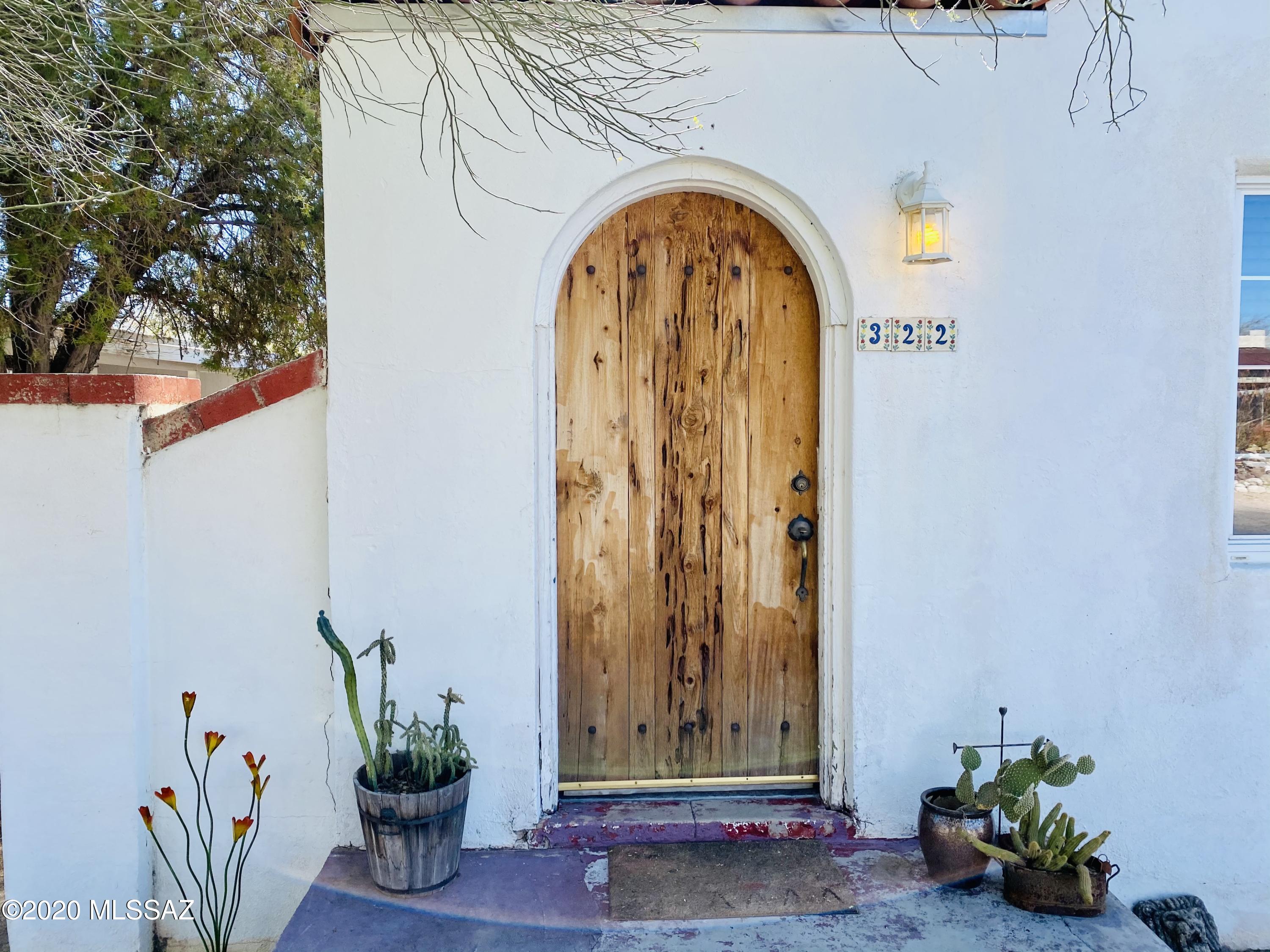 Charming 3 bd/2 ba Feldman's Bungalow with open-concept floor plan, updated kitchen with new cabinetry and granite counters, fresh paint, A/C, original hardwood floors, gardens on drip, 2 covered patios, and very nice curb appeal. Walking distance to UA, 4th Avenue, and downtown... an amazing find! Workshop is HUGE and has an A/C. Lot is pool-sized & can even have a second unit built on it!