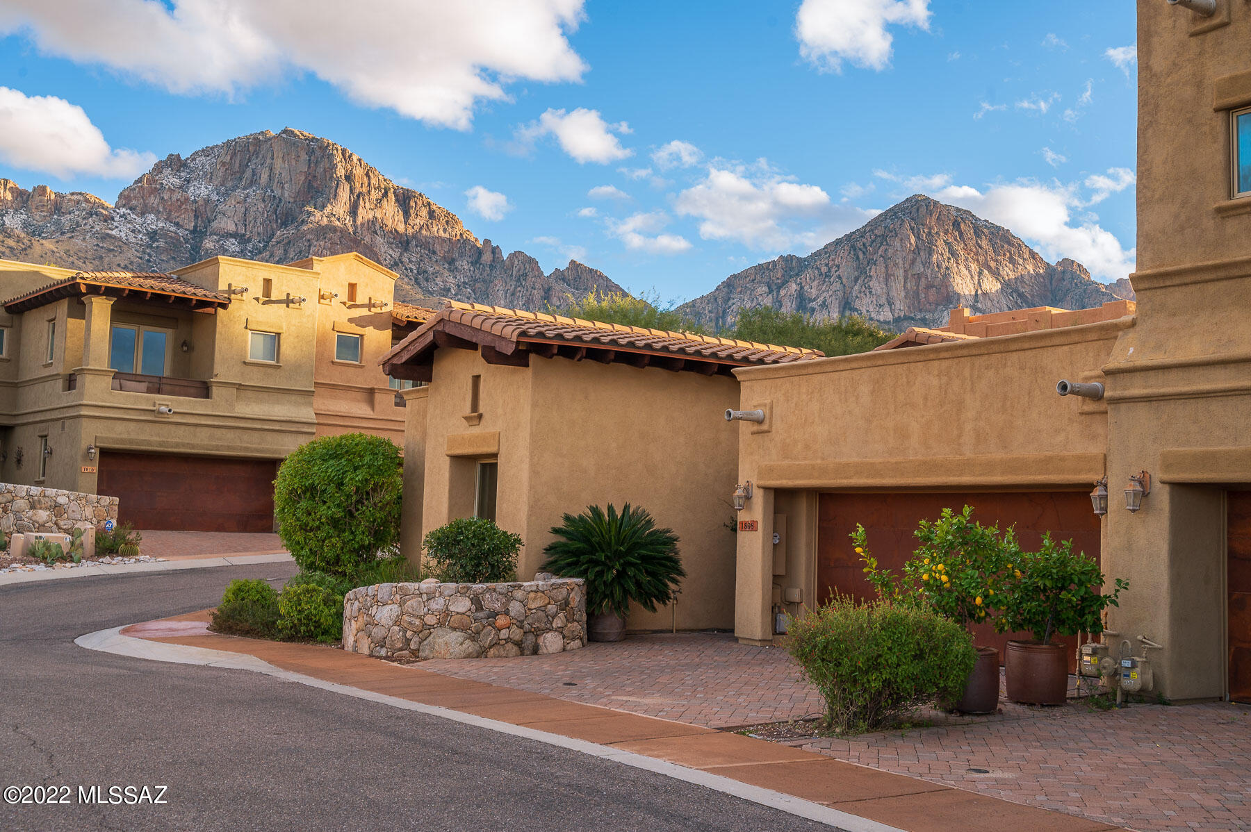 Extremely Energy Efficient, former model, corner lot, Town Home with upgrades for the distinguishing eye. The stone accents, stone walls, and Waterfall-River Landscaping including a Gas Fire-pit bring to life an Old World Charm. Comfort, Relaxed Luxury in a Guard Gated Community, borders Coronado National Forest and Catalina State Park with world-renowned resorts and award-winning golf courses, Oro Valley/Tucson's famous ''The Loop'' walking/biking 130-mile path just minutes away. Fine dining, shopping, and medical care are nearby. This home boasts Expansive Vaulted Ceilings with Wood Beams, a custom iron security door, an 8' alder entryway door, and wood-encased Pella windows and doors. Gas Fireplace Raised Hearth and Mantle. Exquisite Granite Counters and Custom Solid Wood cabinetry; wall-to-wall in the office/den and laundry room. Flooring includes Italian Porcelain in the great room, wood planks in the office, and Berber carpet in the bedrooms. 

The gourmet Kitchen boasts stunning Chef style Viking appliances plus a Viking Wine Cooler. Glass Pendant Lights hang over Breakfast Bar.  Luxury Spa Baths sporting designer finishes and upgraded Kohler Fixtures. Ceiling fans and designer lighting fixtures throughout.  Gas furnace, Gas Hot water heater, Central Vacuum system, Soft Water Loop. Covered Patio, Sound System, Insulated Rustic Metal Garage Door, and Brick Paver Driveway.

Now is your chance to Enjoy the Exotic Hummingbirds that frequent this oasis year-round and the breathtaking mountain views with sweet fresh air.