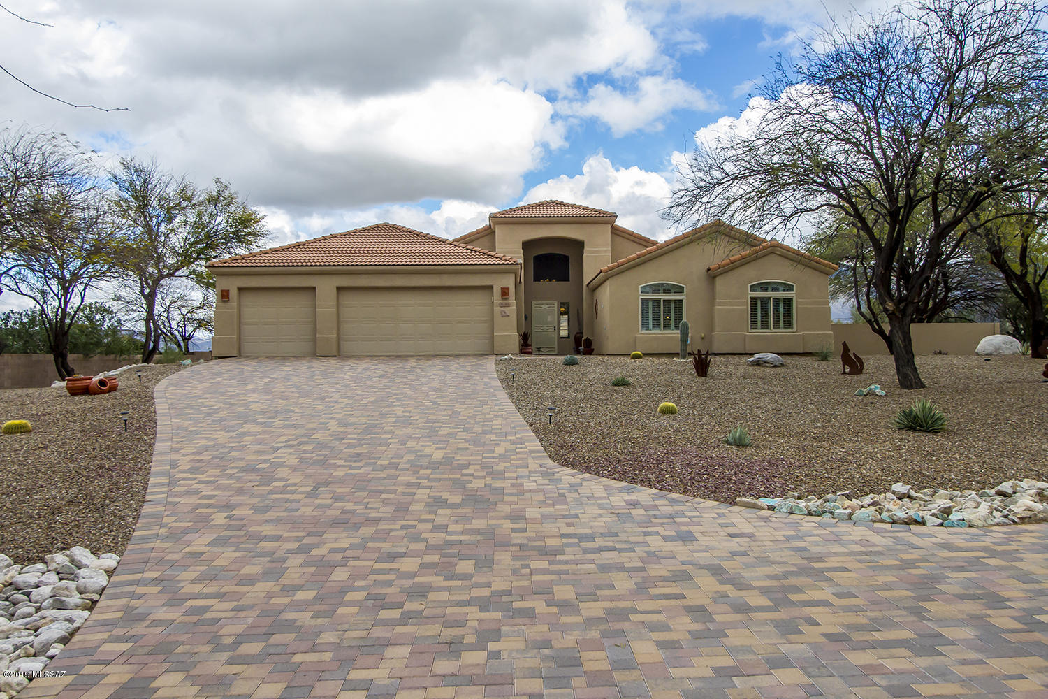 You will not be disappointed with this meticulous maintained home with beautiful views of the Catalina Mountains to the Rincon Mountains. Enjoy the views from the covered patio as well as from many rooms of the home.  Open kitchen to family room is equipped with newly granite counter tops and stainless steel appliances with a walk-in pantry. Inviting floor plan with central vac and a gas fireplace in the family room. The backyard has a built in BBQ, water fountain and ample space to install a pool is so desired. Nicely landscaped and a brick paved driveway all situated on 1.2 acres in a small gated community just waiting for you to call this beautiful house your next home.