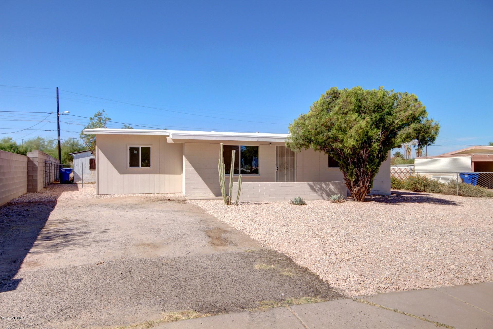 Absolutely Charming 1950's Ranch Style Home with great curb appeal nestled on a large lot. Tastefully updated with soothing interior palette, beautiful tile floor, vaulted ceilings, and lots of natural light throughout. Spacious new eat-in kitchen features stylish granite counters, pantry, patio access, and plethora of distressed wood cabinetry. Create a feast with family and friends. Close to downtown, U of A, Pima College, Mercado and easy access to the busline and streetcar!