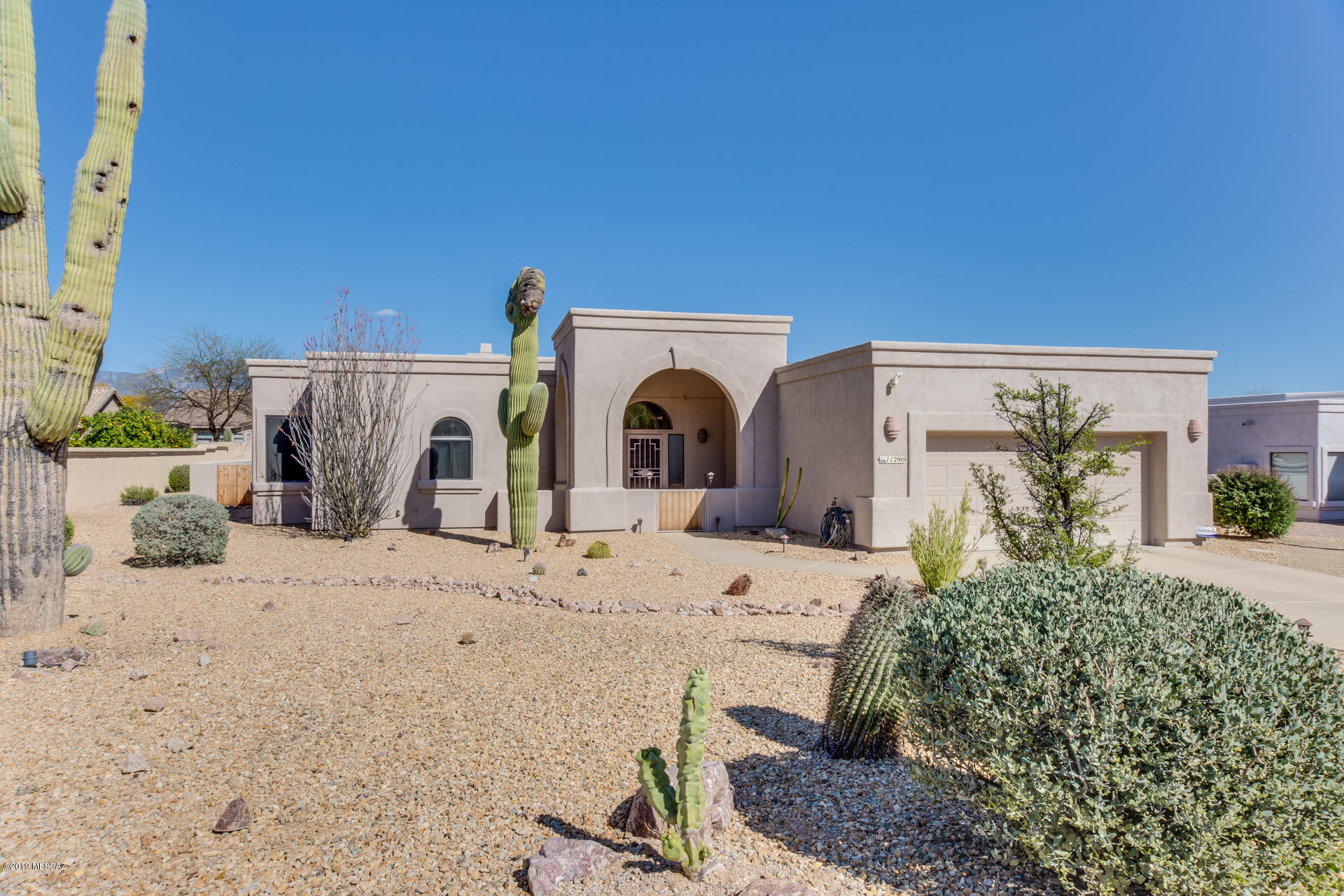 Impeccable, bright & airy home  in the heart of Oro Valley offering a gated front courtyard, 3 bedrooms, 2 full baths (1,907 sqft), 2-car garage, plus front and rear mountain views. Open concept, split bedroom plan boasts a Great room with neutral ceramic tile, gas fireplace and picture windows. Large, open Kitchen offers ample countertop and cabinet space plus a breakfast nook with bay window, wood blinds and coffered ceiling. Master suite hosts a luxury bath with jetted tub, dual glass block windows, walk-in shower and his/hers walk-in closets. Second bedroom accesses hall bath. Spacious rear yard with extended covered patio. Professionally landscaped. Convenient to shopping, dining, Oro Valley aquatic center, parks and entertainment. A must see!
