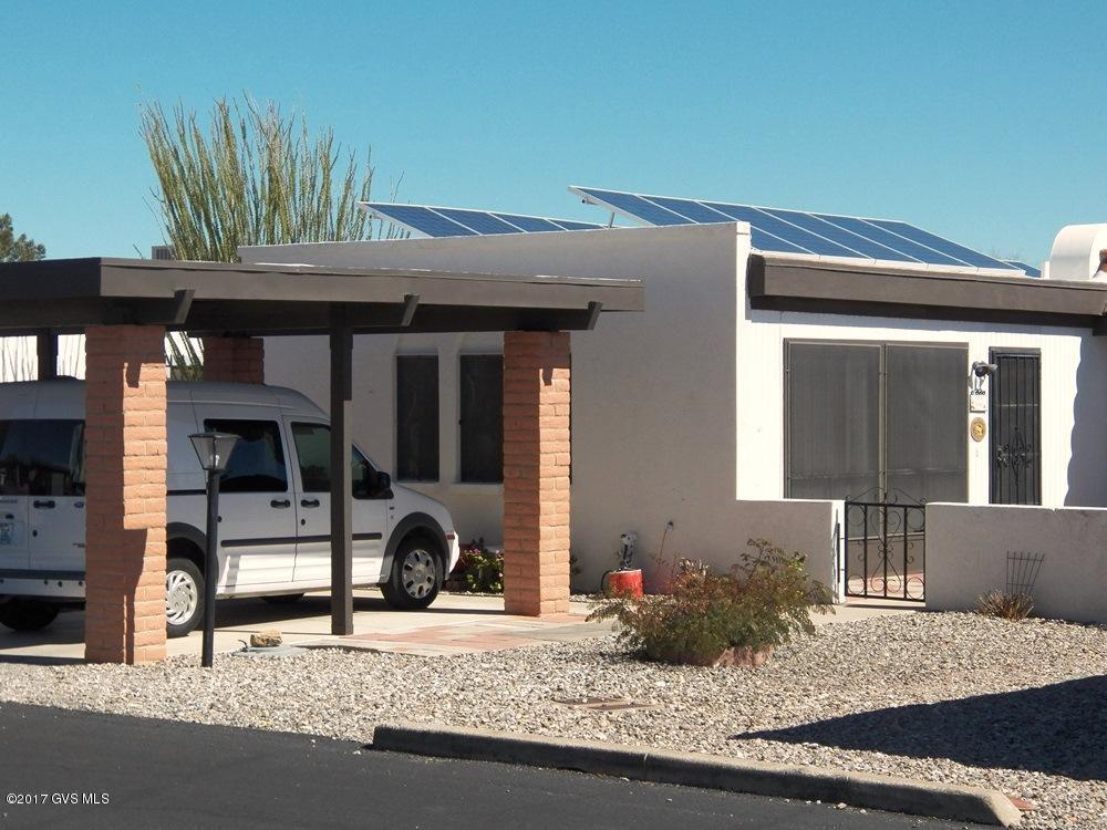 Super energy efficient 100 percent solar powered home. Owned system, not leased. 22 rooftop panels under warranty. Save $100's of dollars in utility bills. Newer HVAC unit and water heater installed in this 1300sf end unit townhome on an oversized lot. 2BR, 2BA with heated/cooled Arizona room. Very light interior. Sold fully furnished. Remodeled kitchen and baths. No dust-collecting carpet-easy care tile floors. Good mountain views from rear patio.