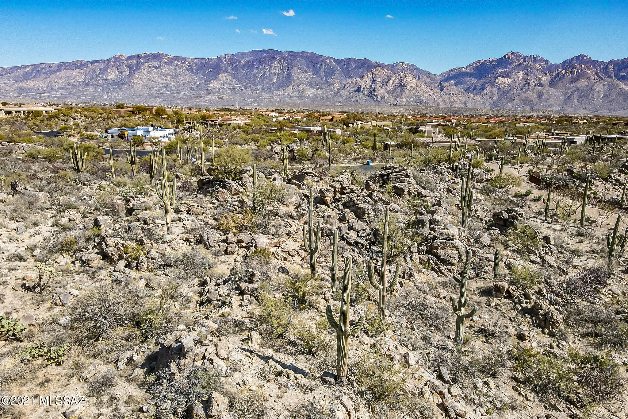 Spectacular custom homesite in the prestigious guard gated Estates at Honey Bee Ridge.  Panoramic mountain views, serene sunrise and sunset views, saguaro studded and gorgeous rock outcroppings make this a very special lot together with backing to a large natural preserve.  Wonderful build pad that will easily accommodate a 6,000 plus square foot dream home.  Nearby golf at the exclusive Stone Canyon Club, The Views Golf Club, and the Oro Valley Community Center featuring El Conquistador Golf, tennis, swimming, fitness, dining and events.  Bike The Loop (135 miles of car-free biking heaven).  Hike the amazing Honey Bee Trail and Catalina State Park.  Fantastic dining, shopping and Farmer's Market nearby.  Such a lovely place to call home.
