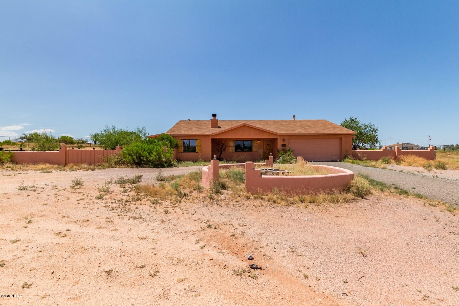 Gorgeous 3 bed, 2 bath home on over an acre corner property.  Wood burning fireplace, central air, new wood plantation shutters. Replacement windows are Renewal by Andersen. Tile throughout home, Two covered patios with access from all 3 bedrooms, and hot tub. 2 car attached garage with washer & dryer, garage door opener, 2 extra refrigerators in garage. Beautiful  panoramic views of the mountains and surrounding desert. Horse property. Enjoy the change of seasons and cooler summer temps. at 4225 elevation.   This lot already has additional hookups for elec & septic. Make your appt to see today.