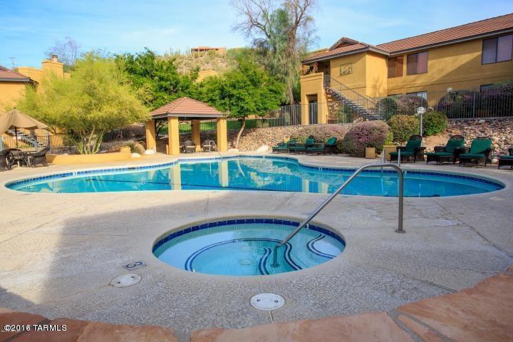 Spacious Catalina Foothills condo overlooking the community pool!  This 3BD/2BA has upgraded granite counter tops and stainless steel appliances.  Front load washer/dryer.  Fireplace, lots of natural light. Located within School District 16.  Call today for a showing, this one won't last long!