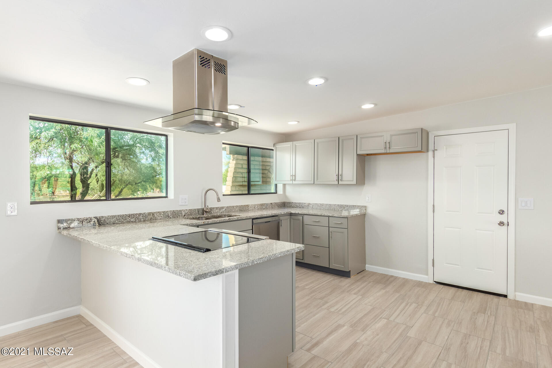 Range Priced: Seller will accept or counter offers $525,000-550,000. Grab this incredible opportunity in Casas Adobes in NW Tucson. Discover a bright living room w/wood-burning fireplace, just perfect to gather around on winter nights. Enjoy the sizable family room with views of the backyard. The eat-in kitchen is fully equipped with stainless steel appliances, granite counters, pantry, recessed lighting, and breakfast bar. The main bedroom boasts plush carpet, sliding-door closet, private bathroom, and patio access. Admire fantastic mountain views from your covered patio and enjoy the sparkling pool on summer days. This is the one you have been looking for.