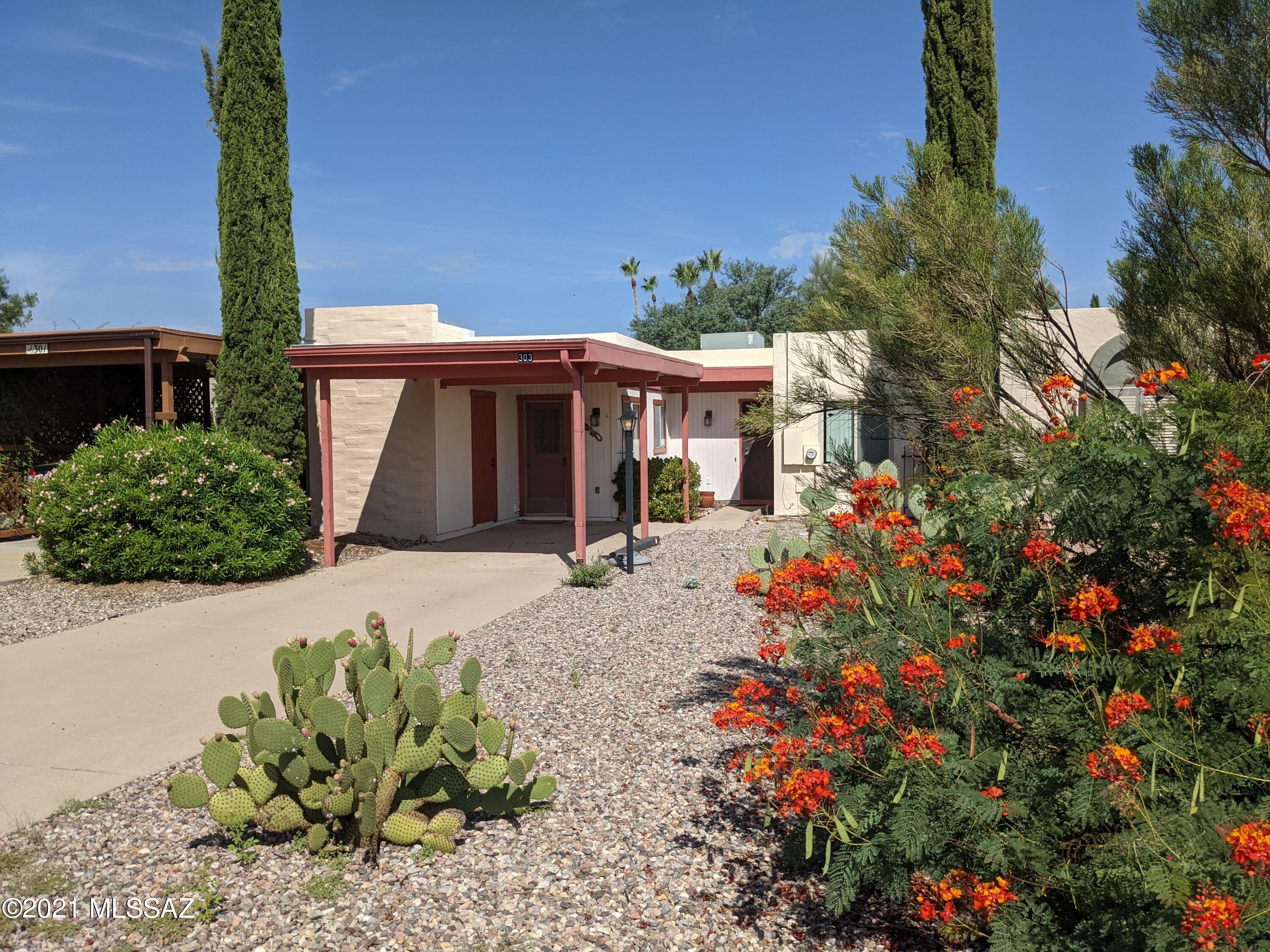Come join the carefree desert lifestyle in this 2 bd/1 ba furnished townhome in Casa Paloma II. This home has front views of the beautiful Santa Rita Mountains and features recently updated granite counters and maple cabinets in kitchen and bathroom. Galley style kitchen with carport access door and laundry closet. Expanded great room combines living room and dining room, great for entertaining, and features built-in bookcase and mini-split HVAC for energy efficiency. Enjoy 3 sets of sliders to the back patio inviting the outside fresh air and nature views in. Master bedroom features expansive closet space and ceiling fan. Bathroom features shower/tub and skylight. Linen closet in hallway. Guest room with wall bed/desk utilizes best use of room until company arrives. Energy saving dual-pane windows and easy-care "no carpet" floors throughout home. Outside storage room under carport. Enclosed pony-wall, paved back patio with strategically planted trees for privacy. Roof recoated in 2019. Perfect for rental, winter retreat or full time! Come! See! Stay!