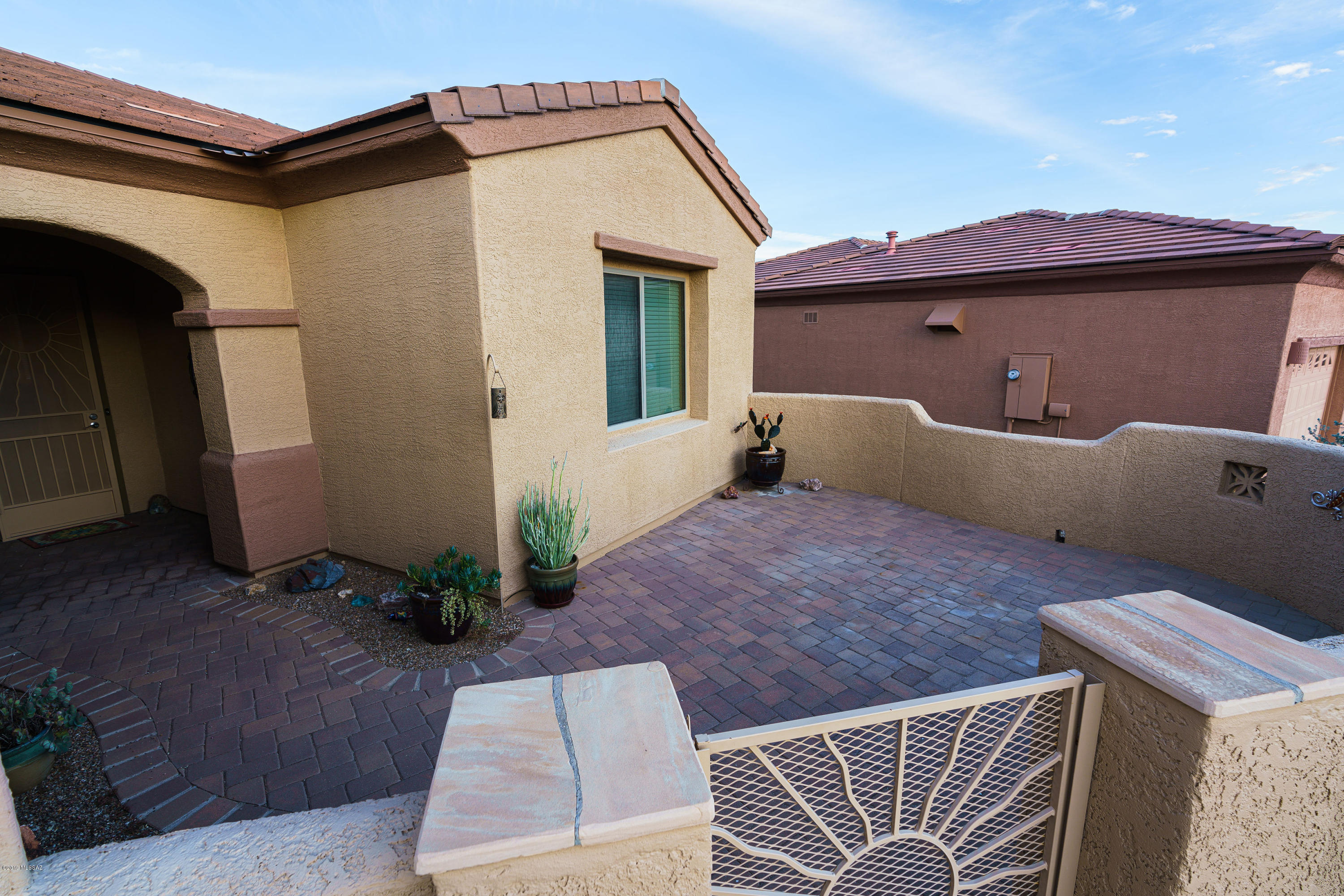 Immaculate San Miguel home where every upgrade was carefully selected, from the beautiful grand entry door to the resort style backyard. Four mature saguaro's and one with 3 arms in the front yard. Spacious upgraded kitchen opens to Great Room ideal for entertaining with tall ceilings and elegant colors throughout. Dark wood cabinets and high end appliances. Tile floors. Large front courtyard with mountain views leads to enclosed front porch through custom wrought iron security screen door. Premium sized backyard has a custom stained concrete patio, horse shoe area, spa, BBQ island with chairs and refrigerator, swimming pool with solar panels to heat, new pool pump with a sand filter system and plenty of space to sit and enjoy the desert vegetation and mountain views. And so much more!